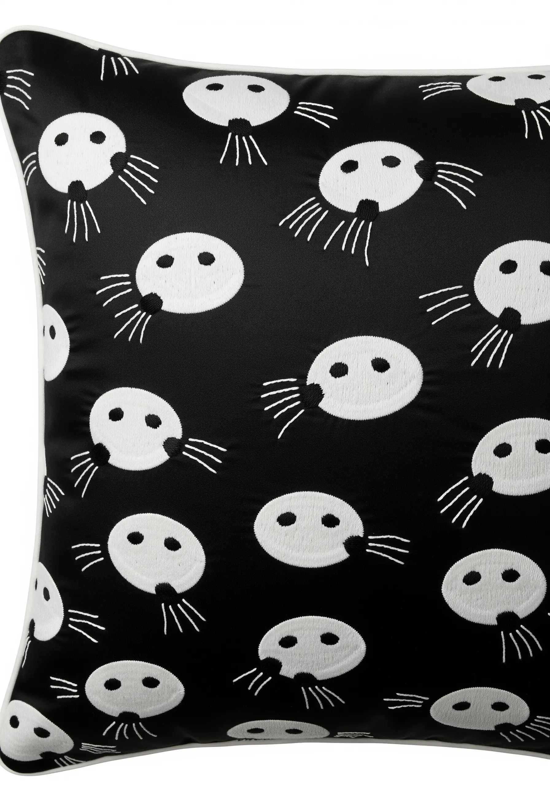 A modern, graphic repeat pattern of white ermine spots on a black cushion.
