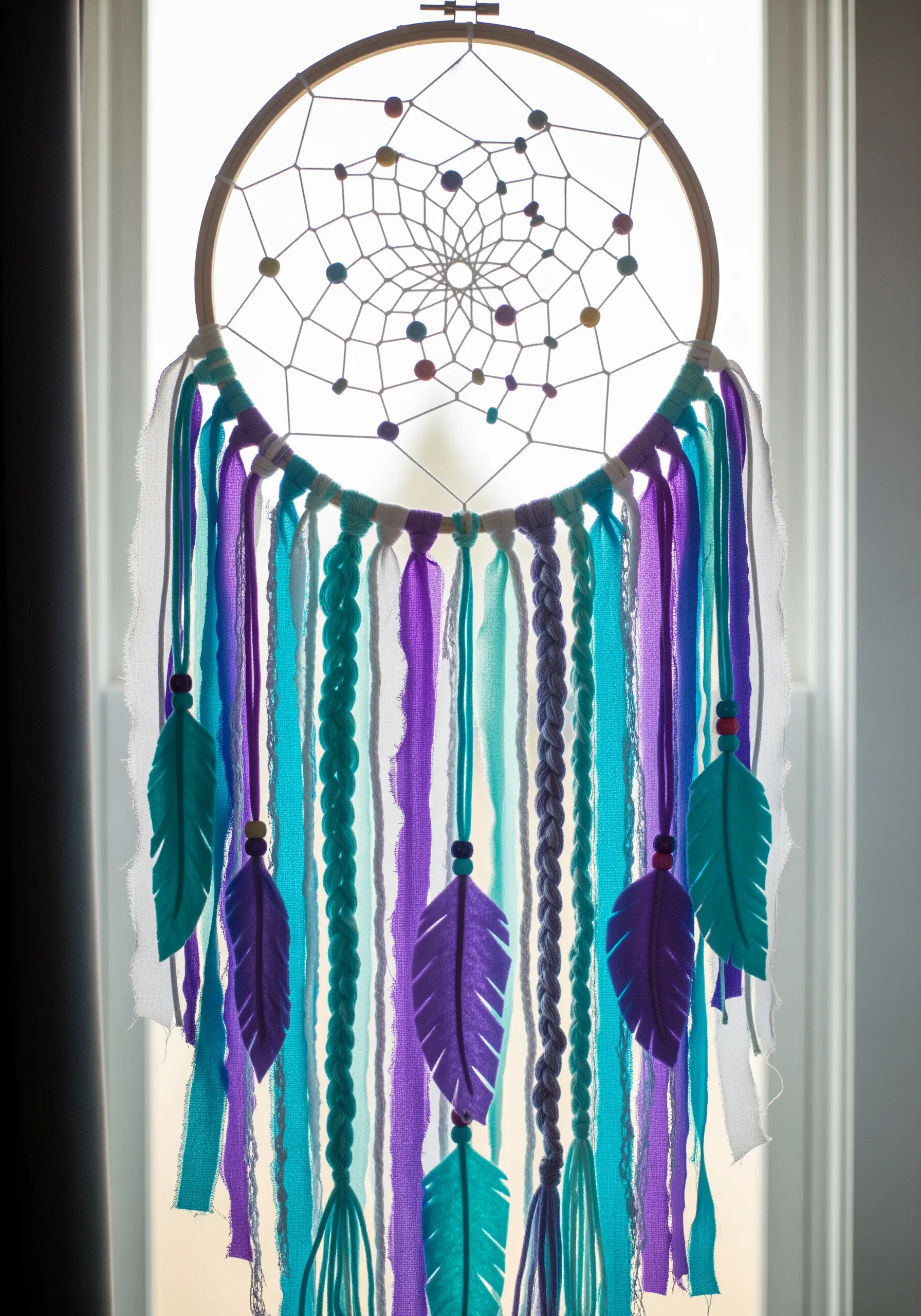 Dreamcatcher with purple and teal yarn fringe