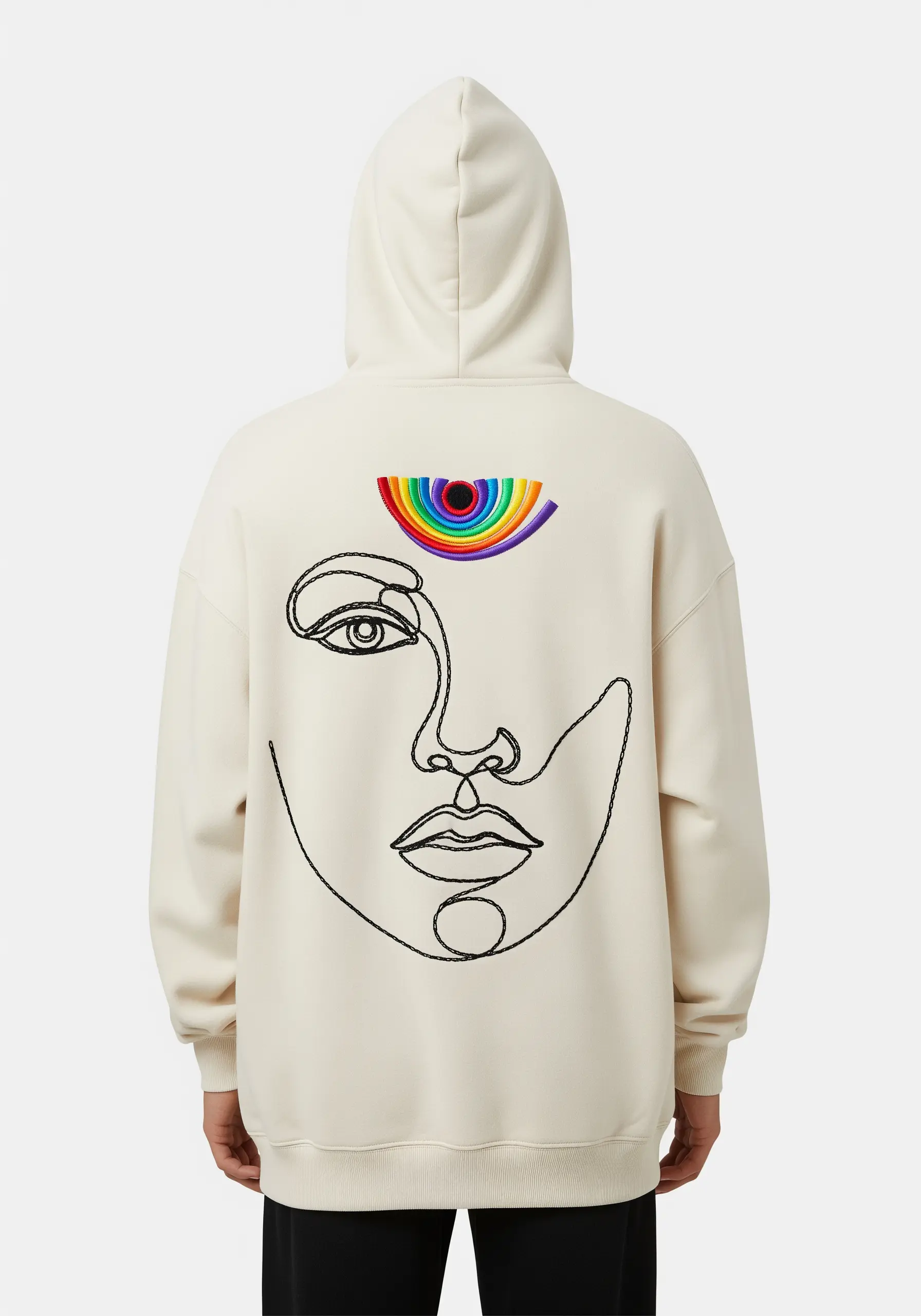 Minimalist one-line art face with a rainbow-colored third eye on a cream hoodie.