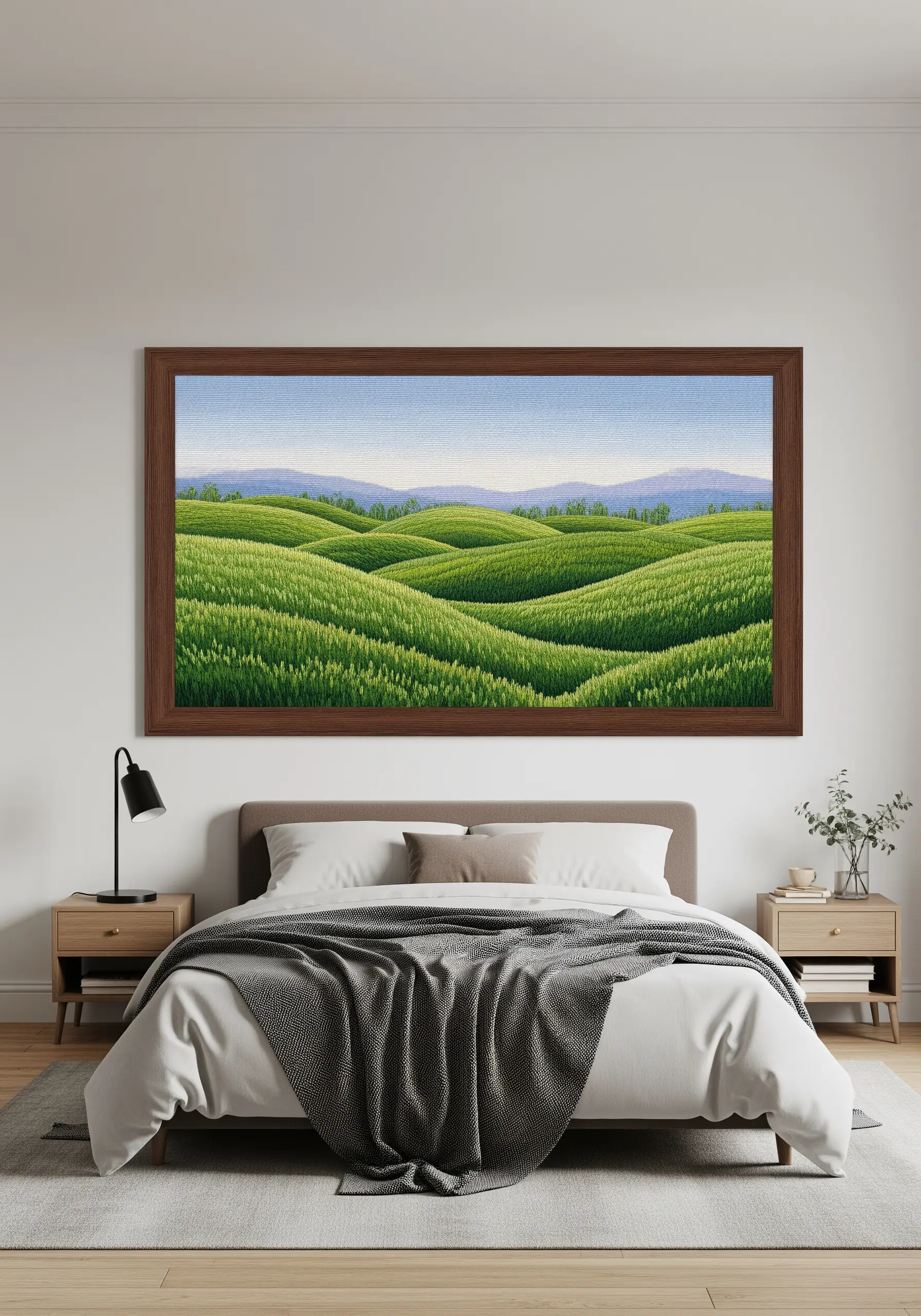A large, framed embroidery of rolling green hills created with dense seed stitches.