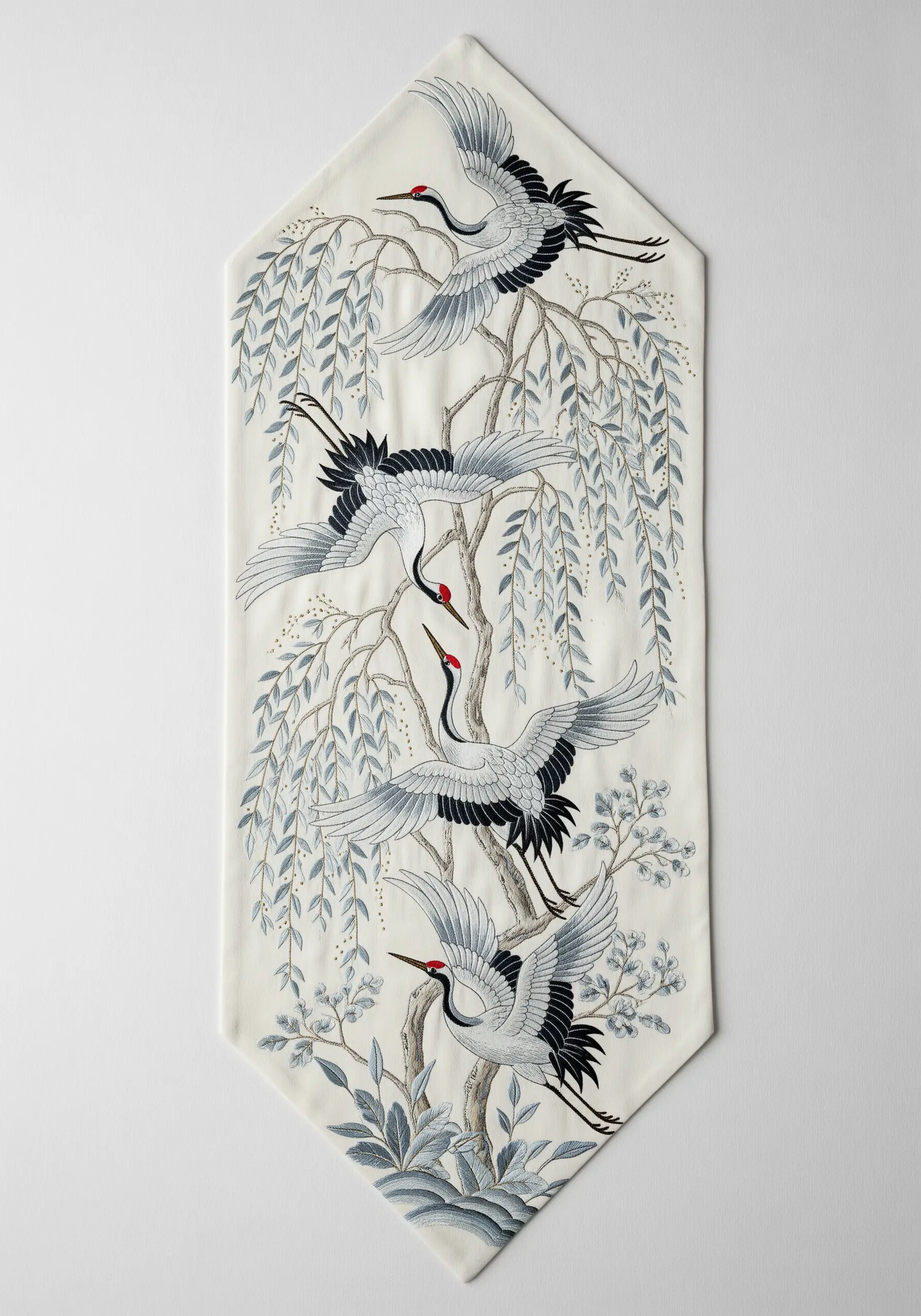 An elegant white table runner with finely embroidered cranes and willow trees in a grayscale palette.
