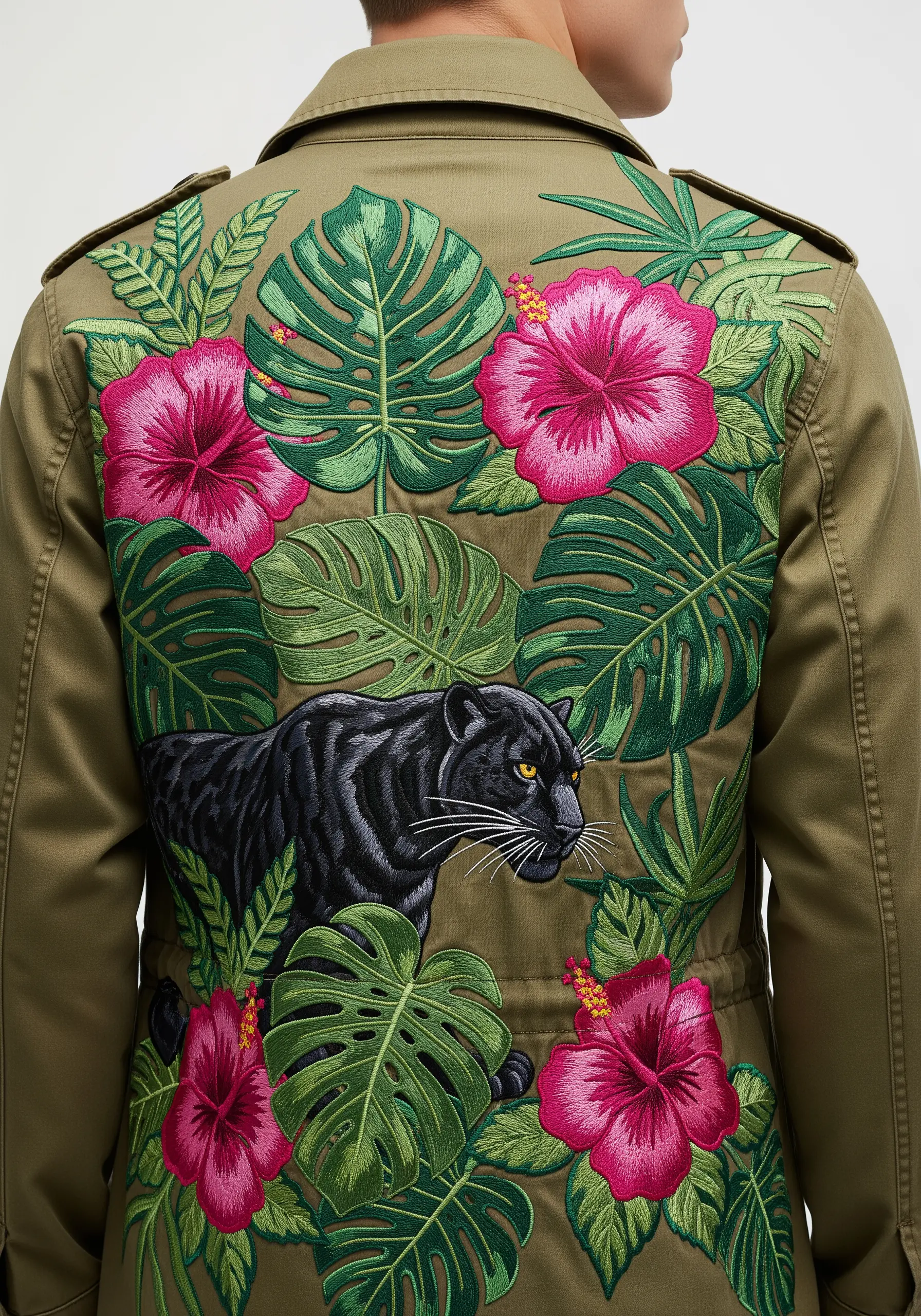 Black panther surrounded by embroidered tropical leaves and pink hibiscus flowers on a jacket.