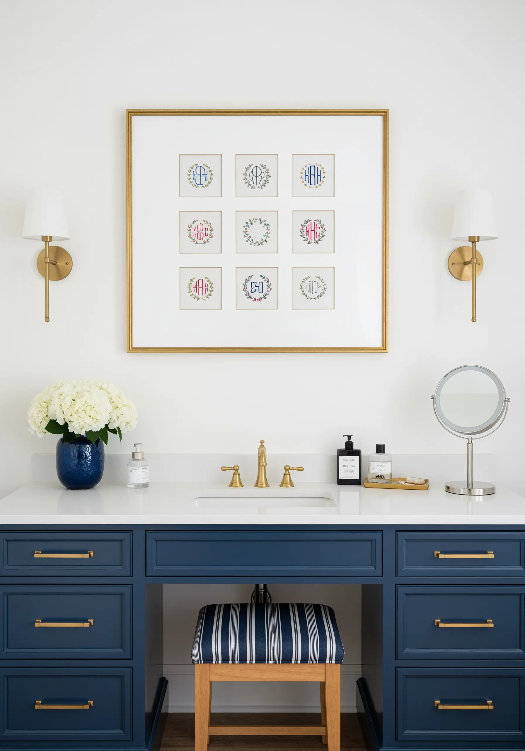 A large gold frame displaying a grid of nine embroidered monogram wreaths.