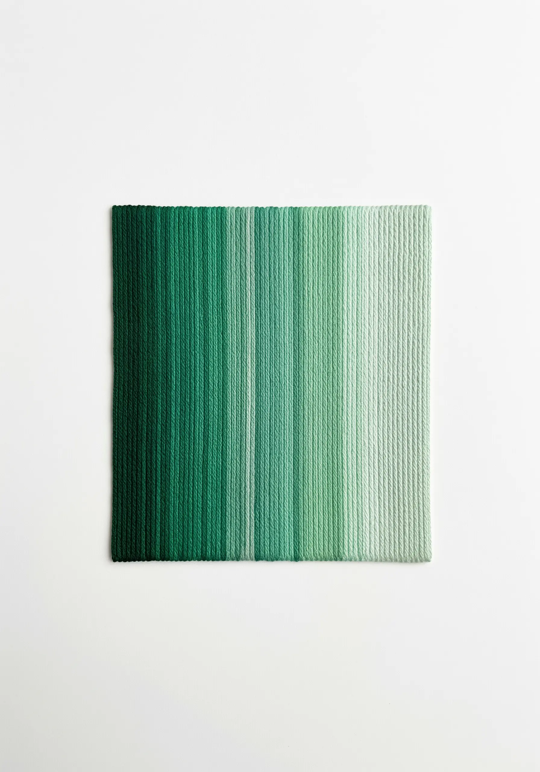 A perfect vertical gradient of green shades created with flawless satin stitch.