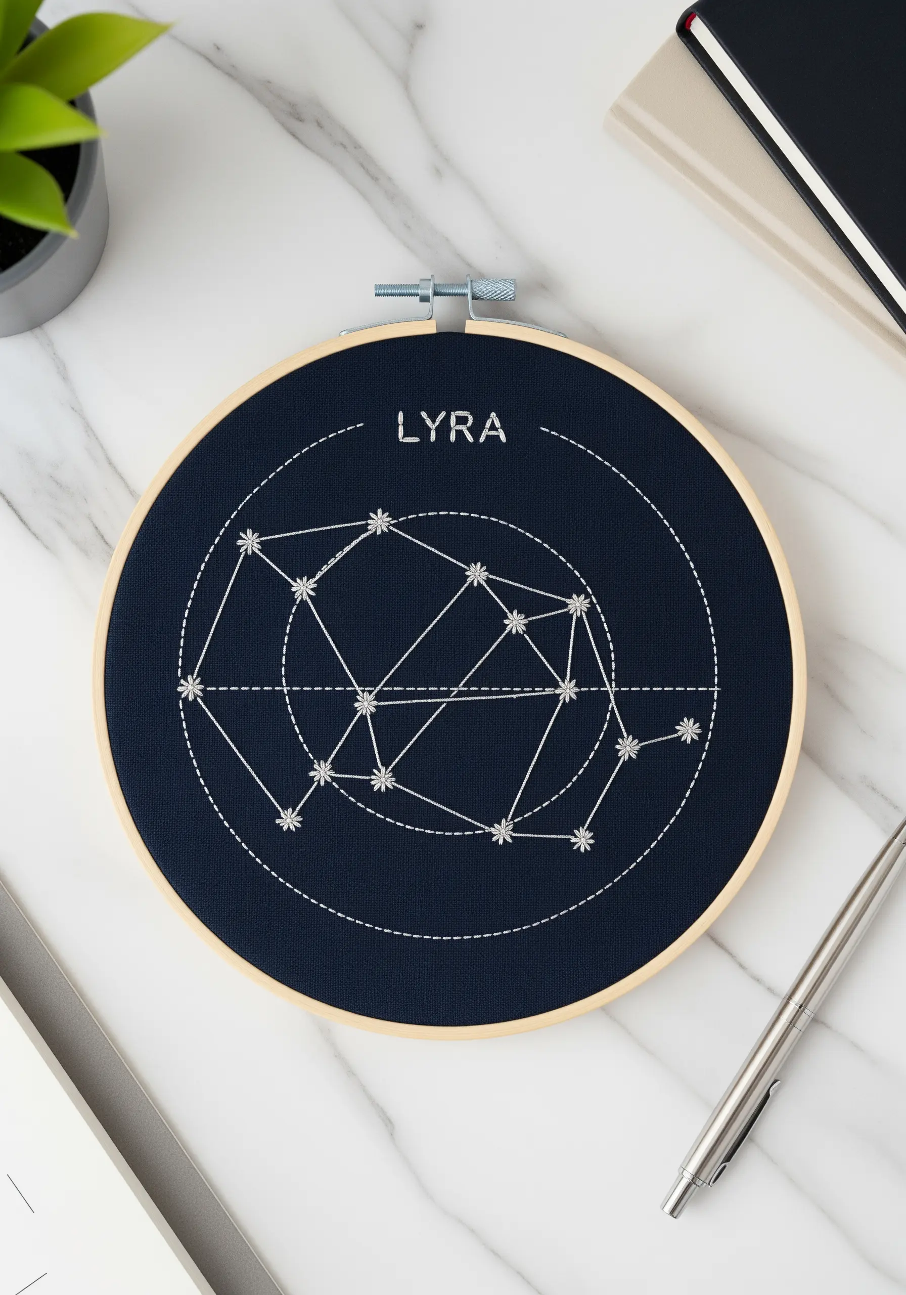 Lyra constellation map stitched in white thread on dark navy fabric.