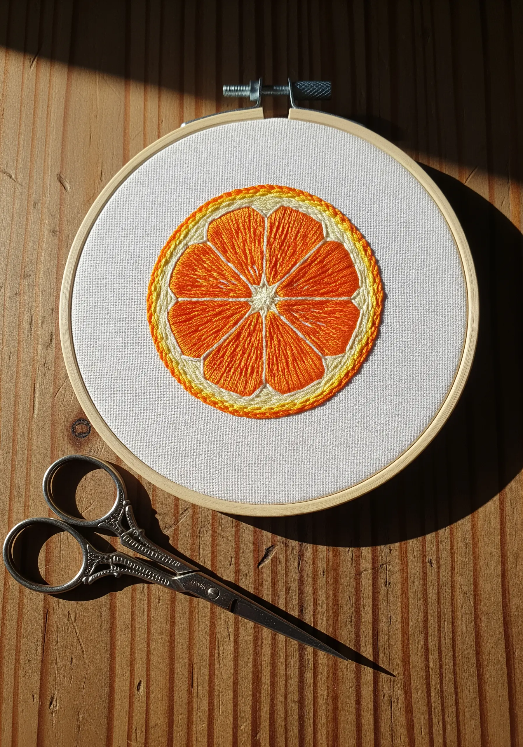 Orange slice embroidery using satin stitch for vibrant fruit segments