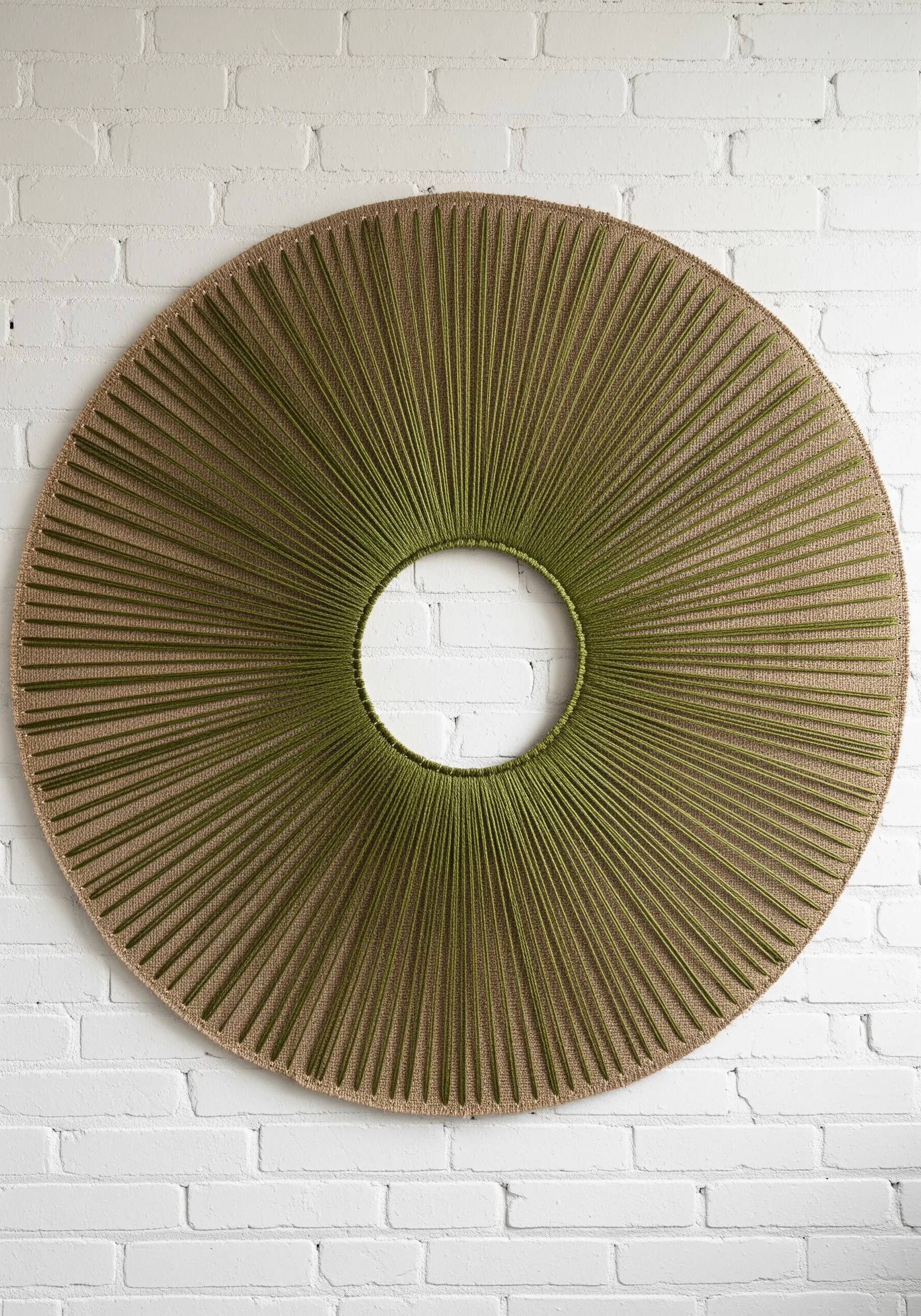 Green thread radiating from an empty center circle on canvas