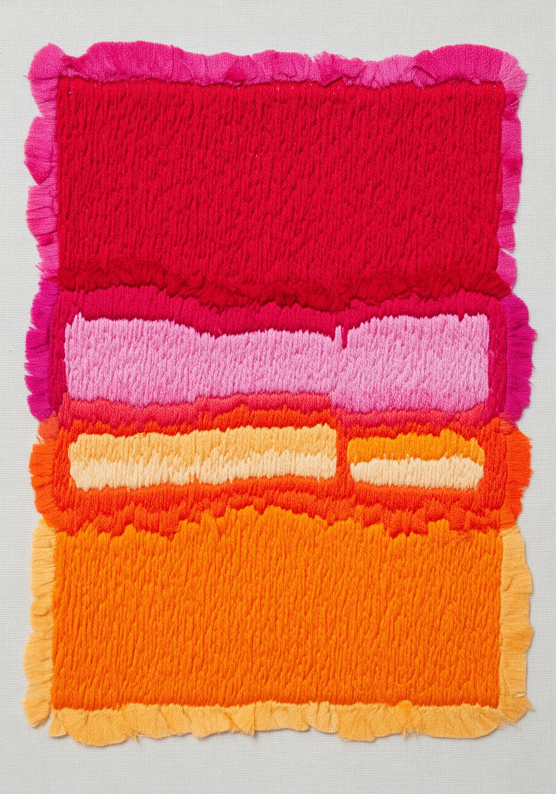 Abstract color block embroidery with fringed edges in warm tones
