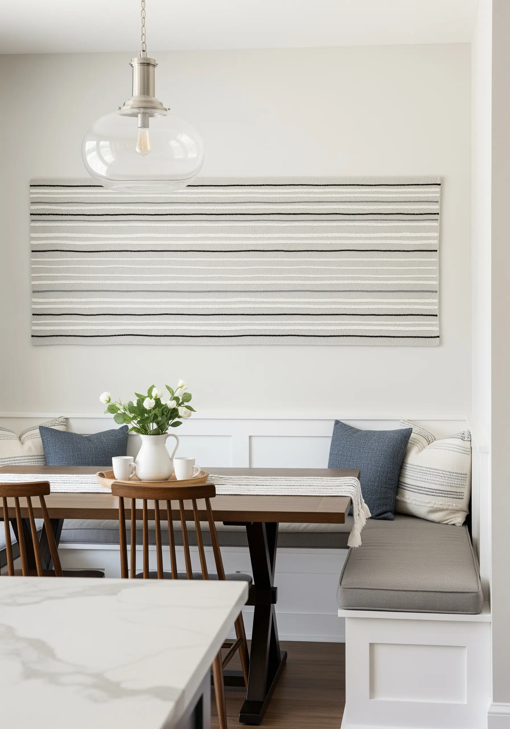 A large, minimalist wall hanging with horizontal stripes of varying neutral textures.