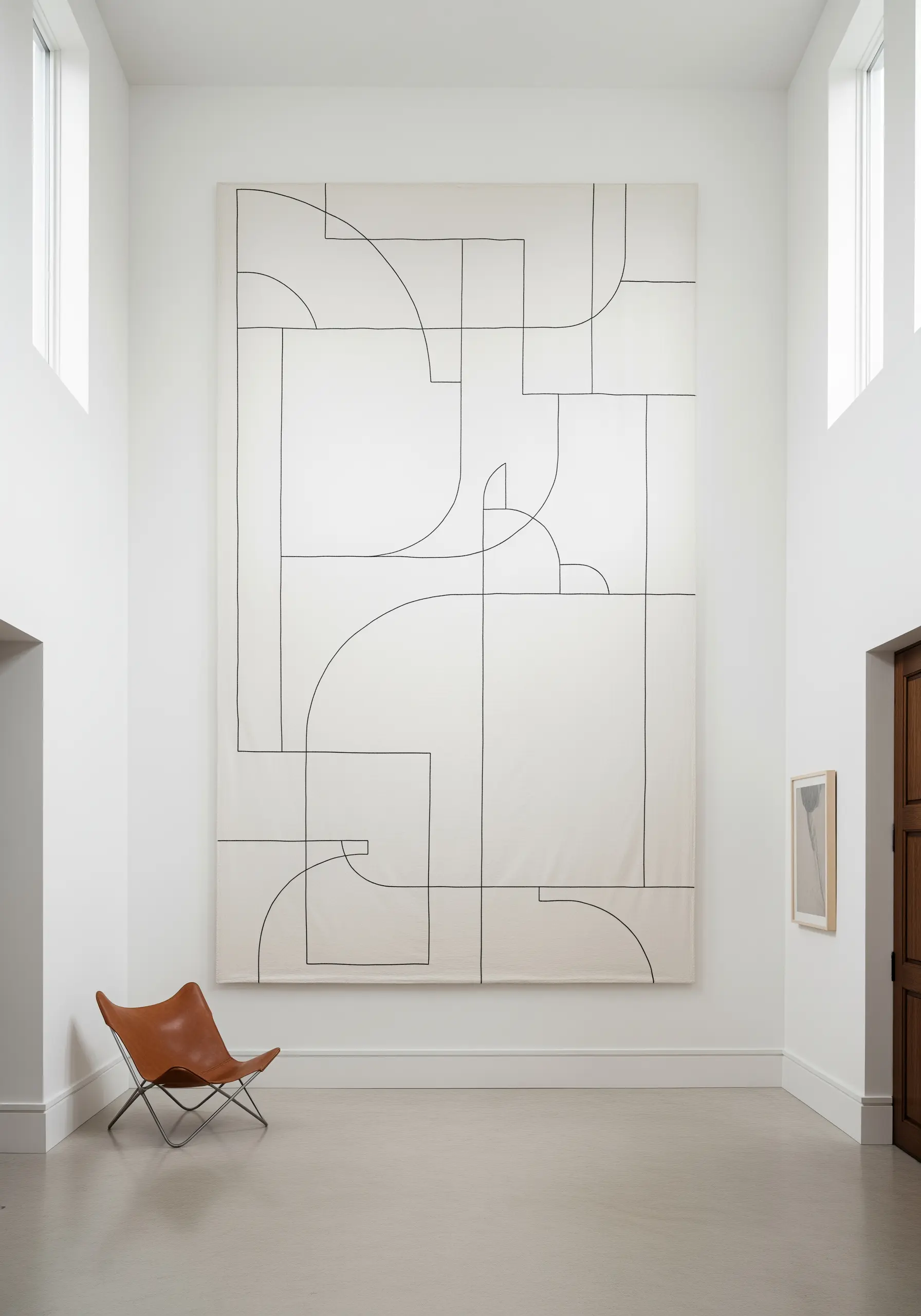 An enormous wall tapestry featuring abstract black lines on a white background.