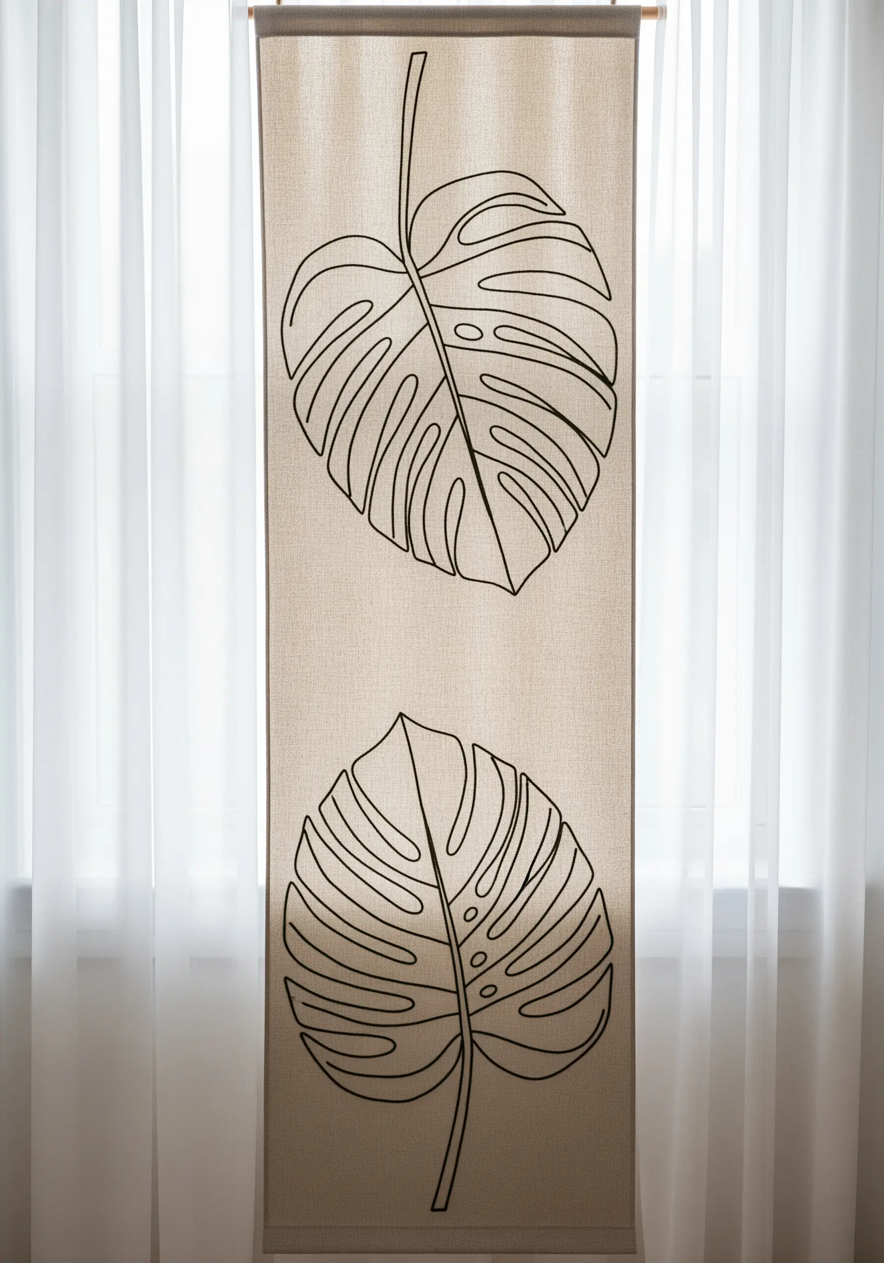 A long, narrow linen wall hanging with two large monstera leaf outlines embroidered in black.