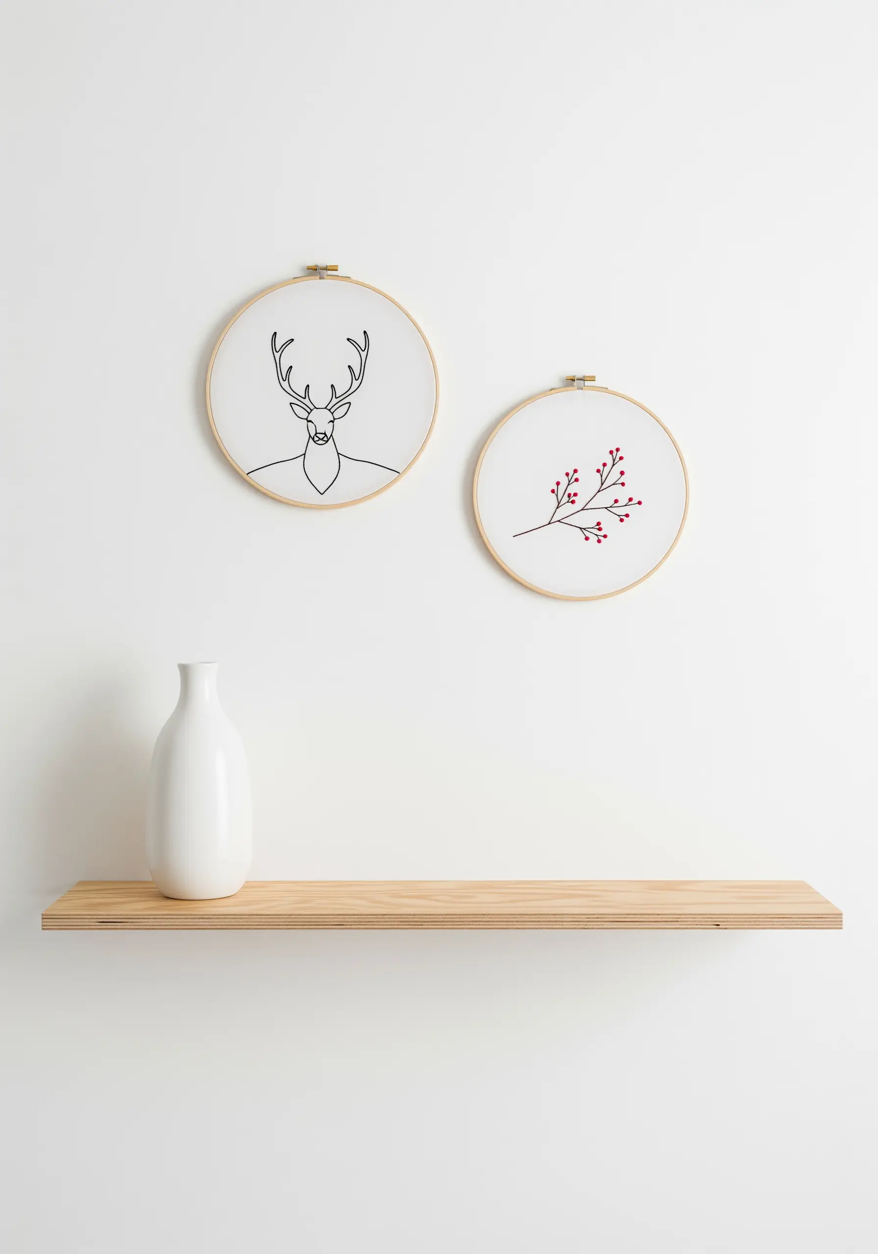 Minimalist line art embroidery of a deer and a branch with red berries.