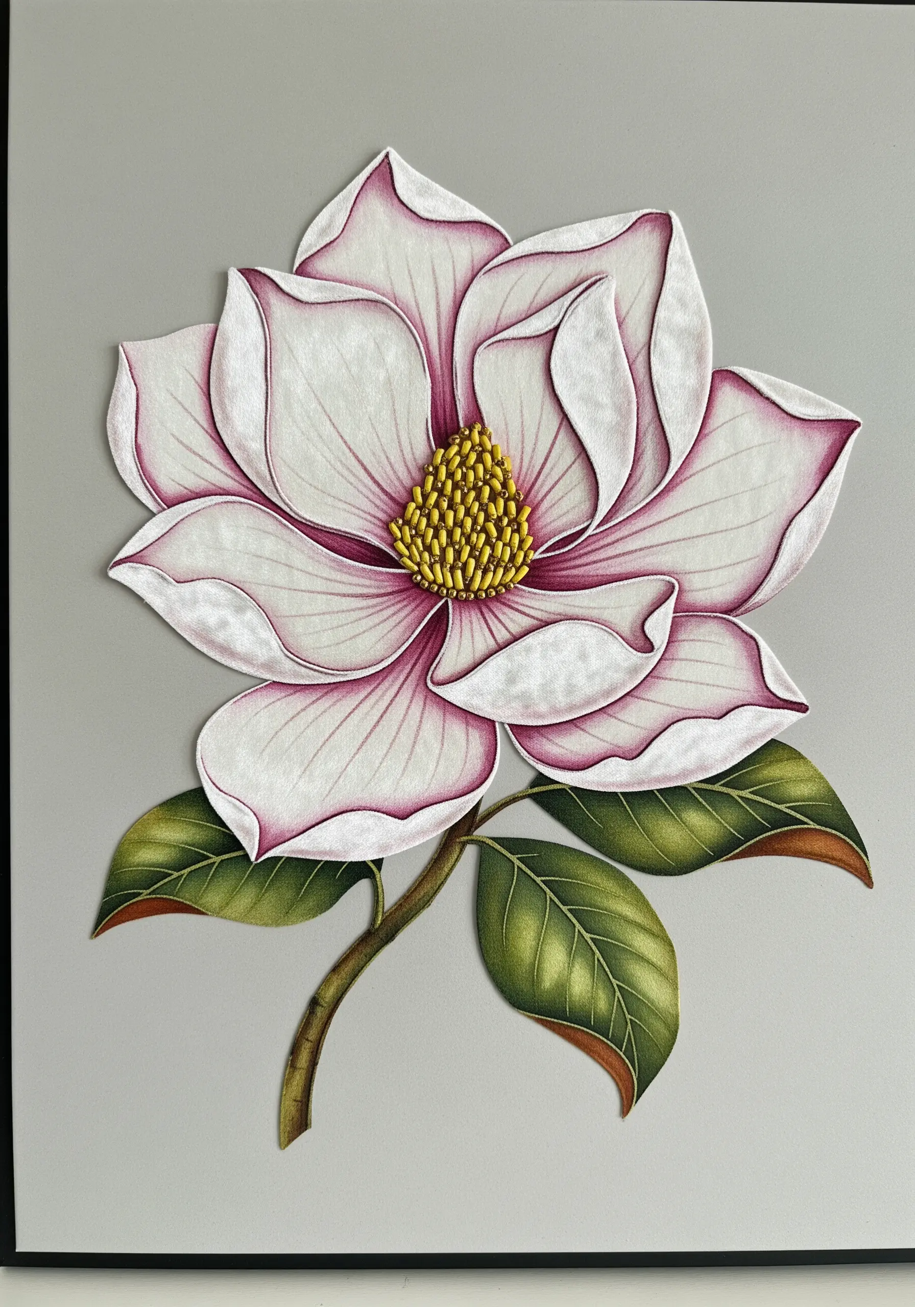 A large, 3D magnolia made from shaped petals with painted details and embroidered edges.