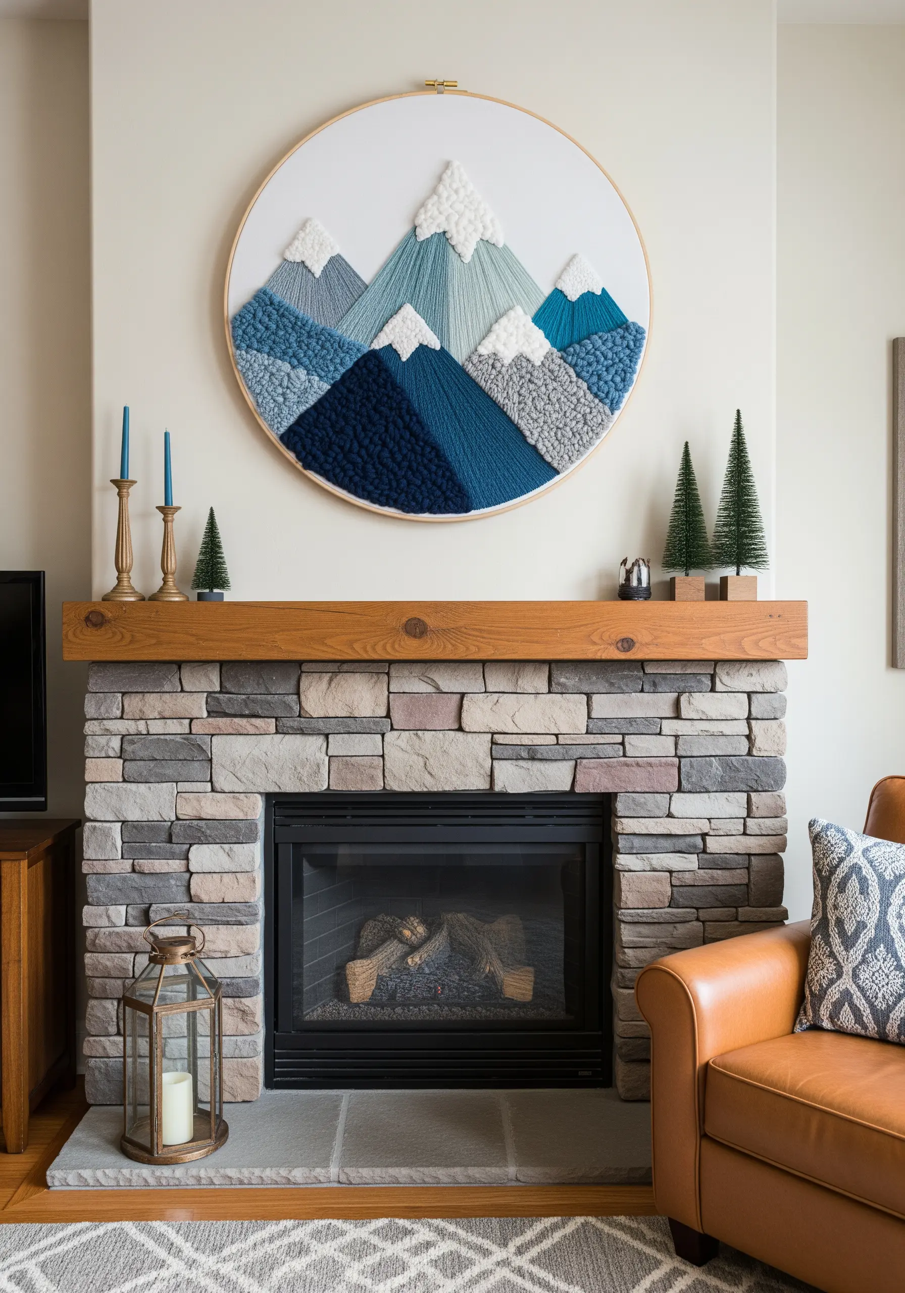 A large embroidery hoop with a textured mountain range in shades of blue and white yarn.