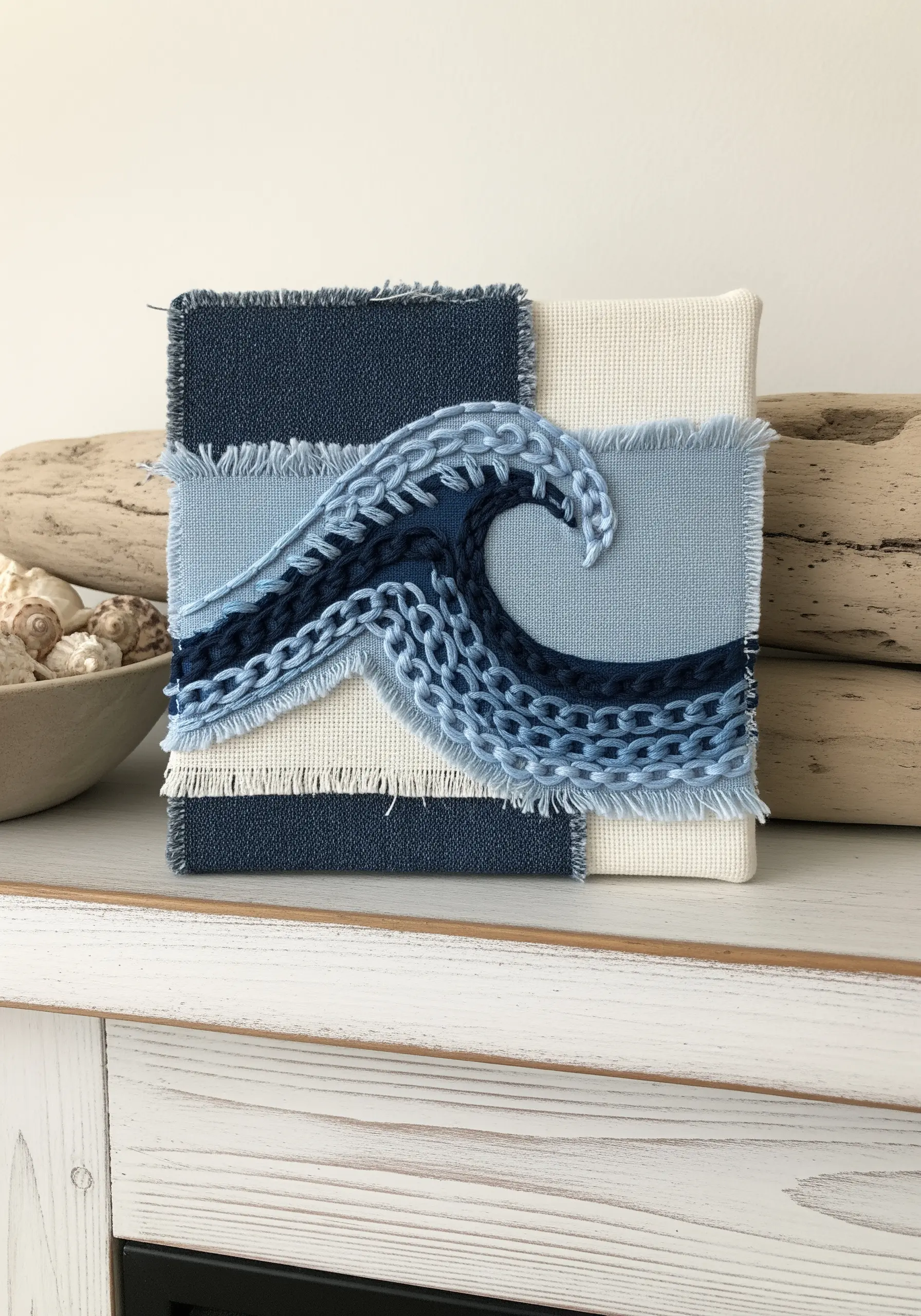 Textured ocean wave created with layered blue fabrics and varied chain stitches.