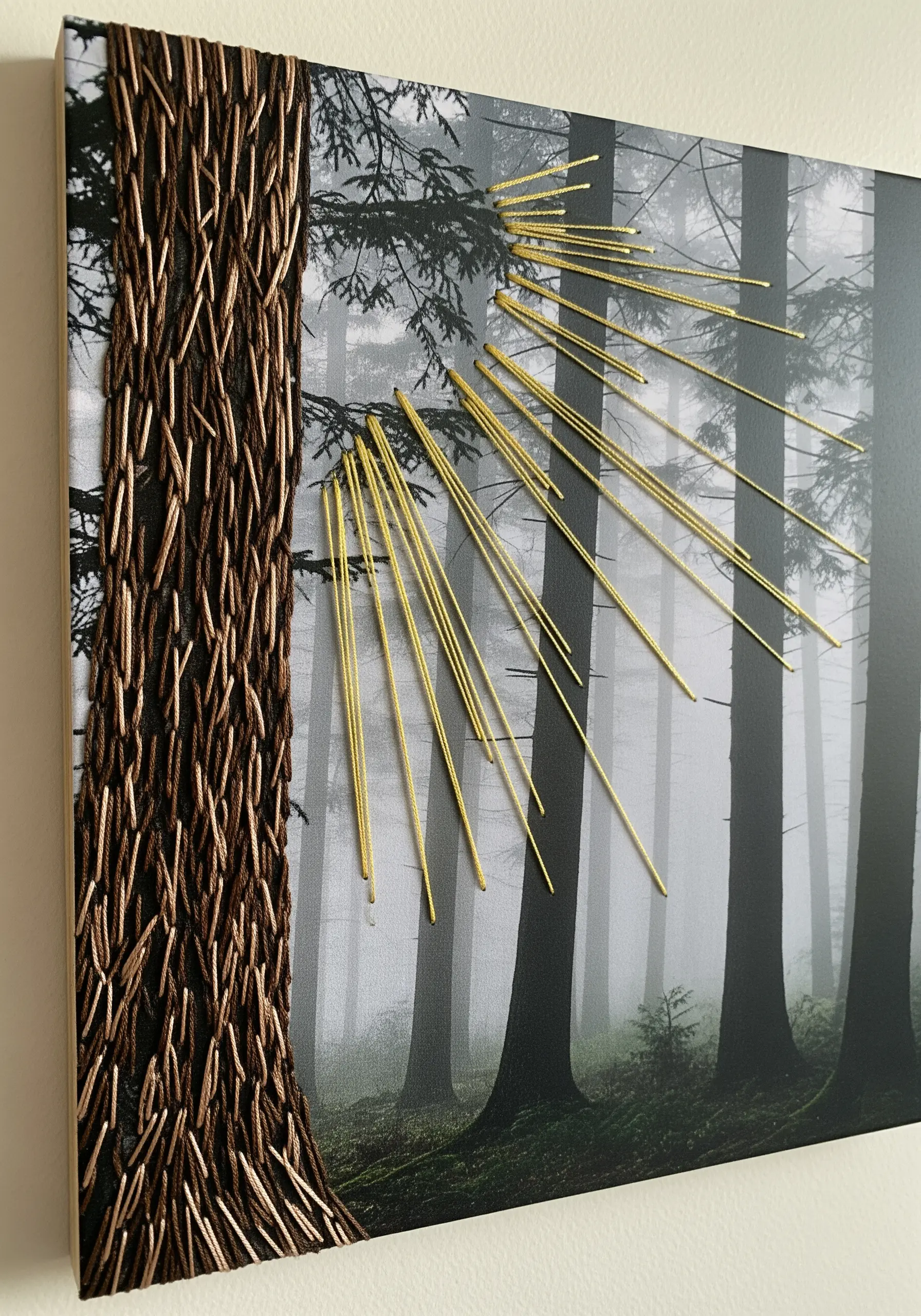 A forest photograph on canvas with embroidered texture on a tree and golden sun rays.