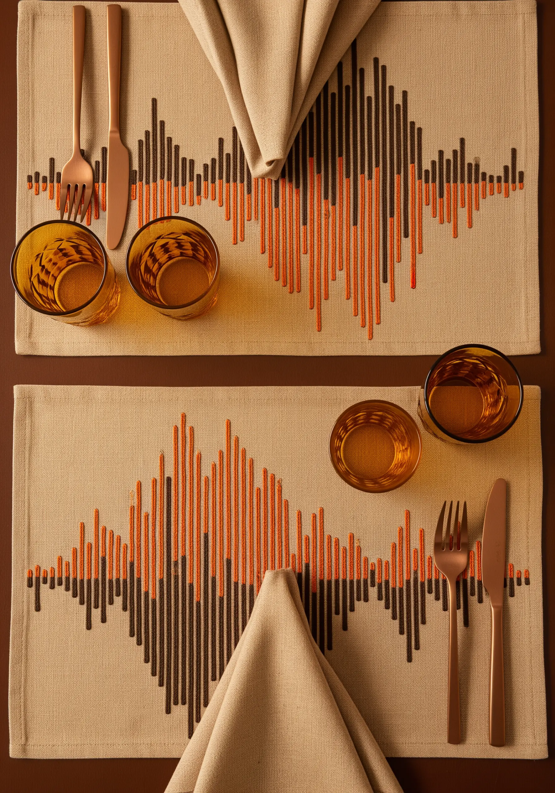 Placemats with embroidered vertical lines in orange and black, resembling a soundwave