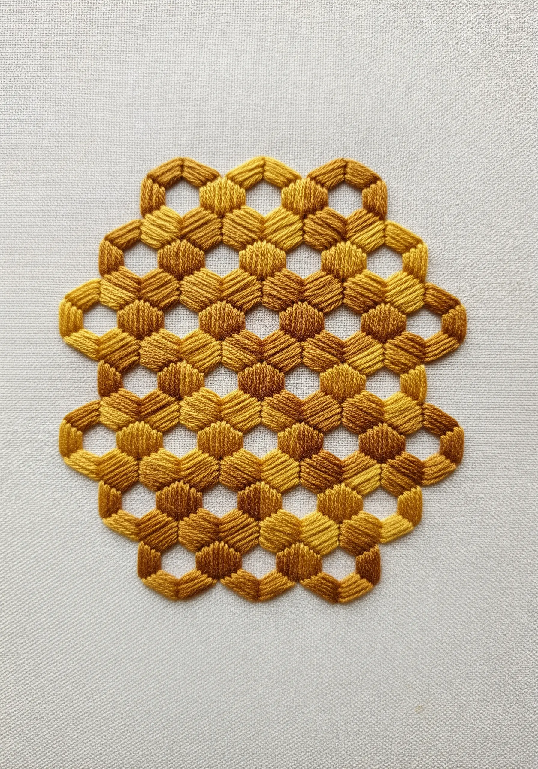A honeycomb mandala in shades of gold, creating a 3D tumbling block illusion.