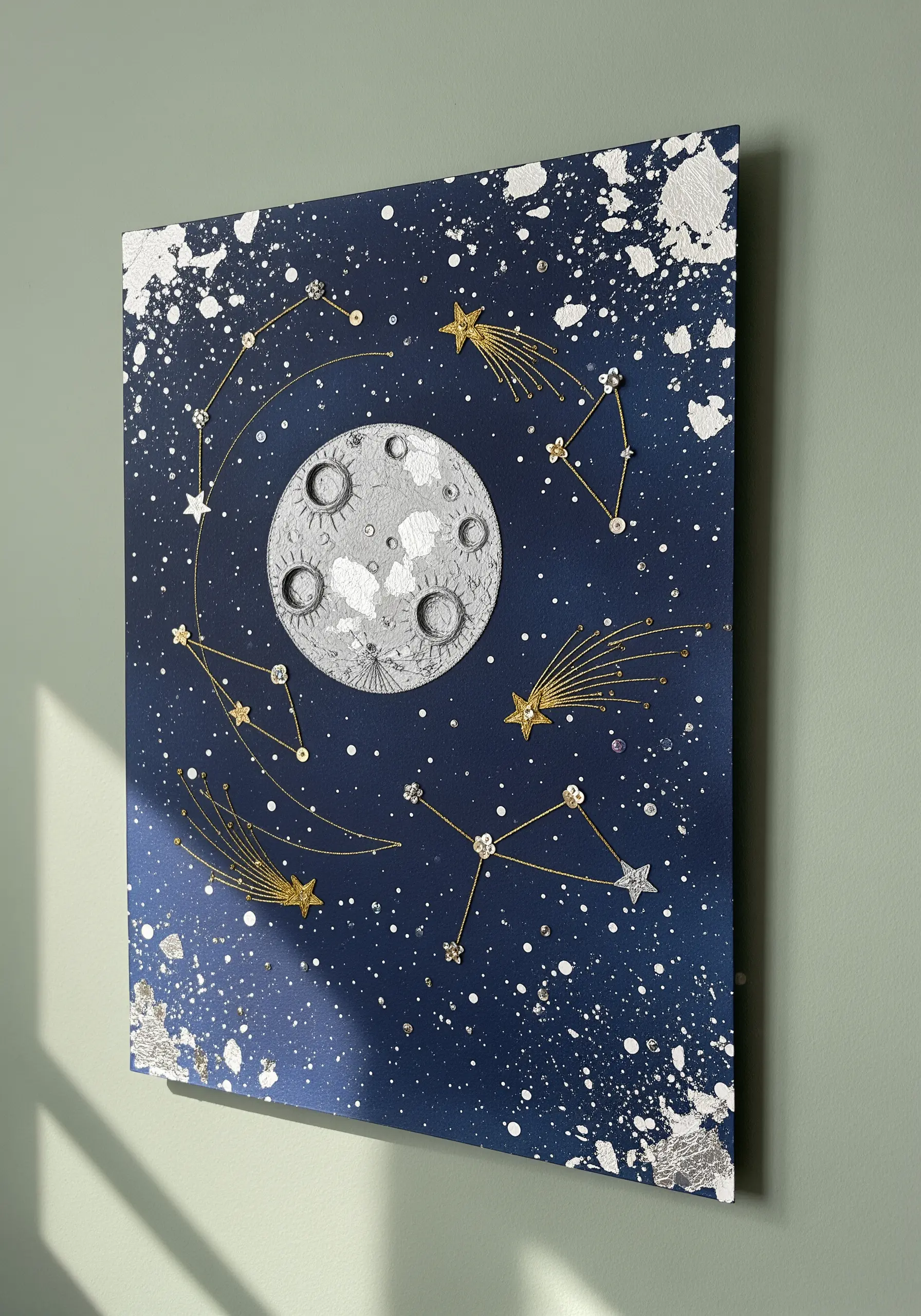 Mixed-media celestial art with gold thread constellations and a textured paper moon.