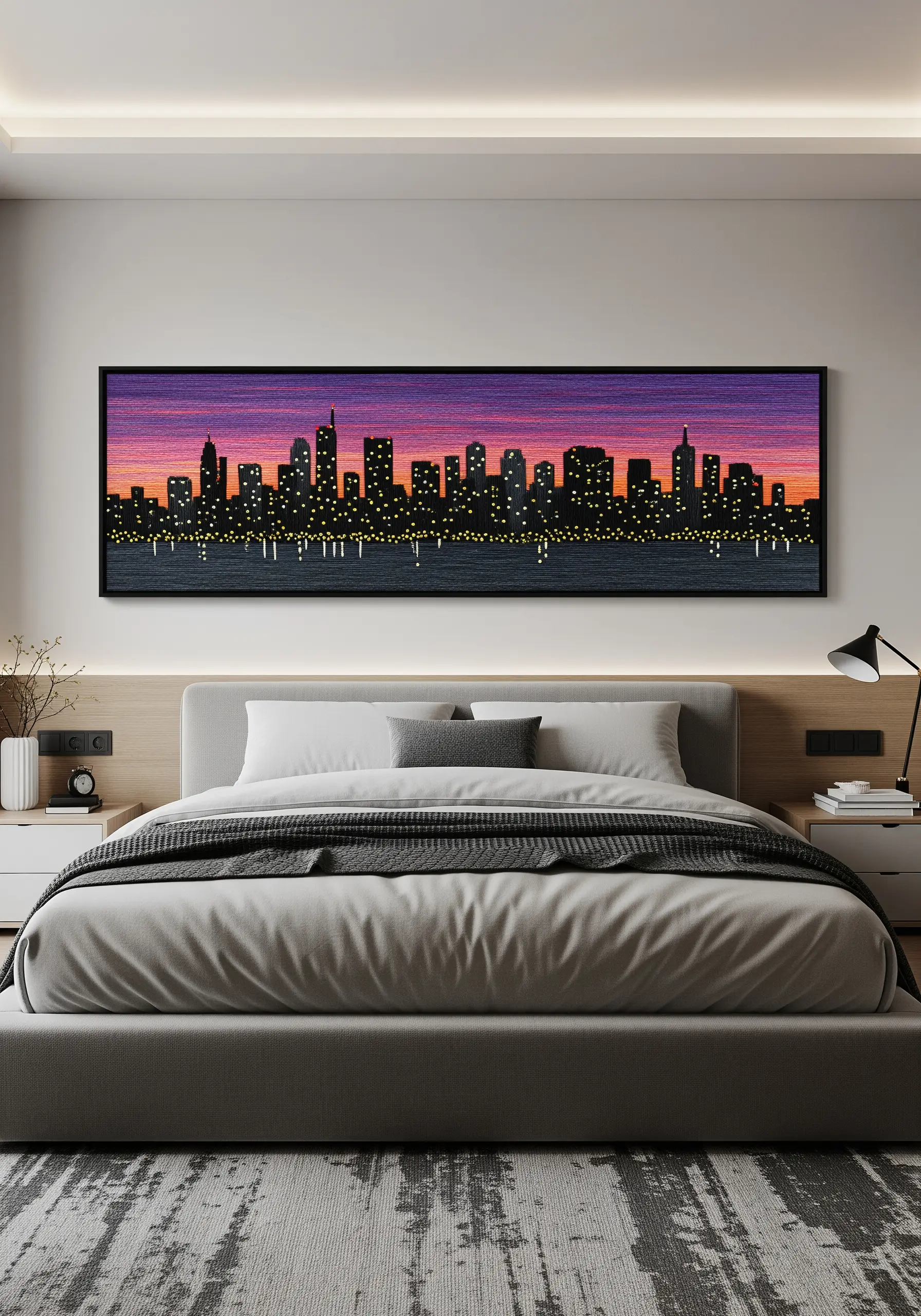 A panoramic embroidery of a city skyline at sunset with a purple and orange gradient sky.