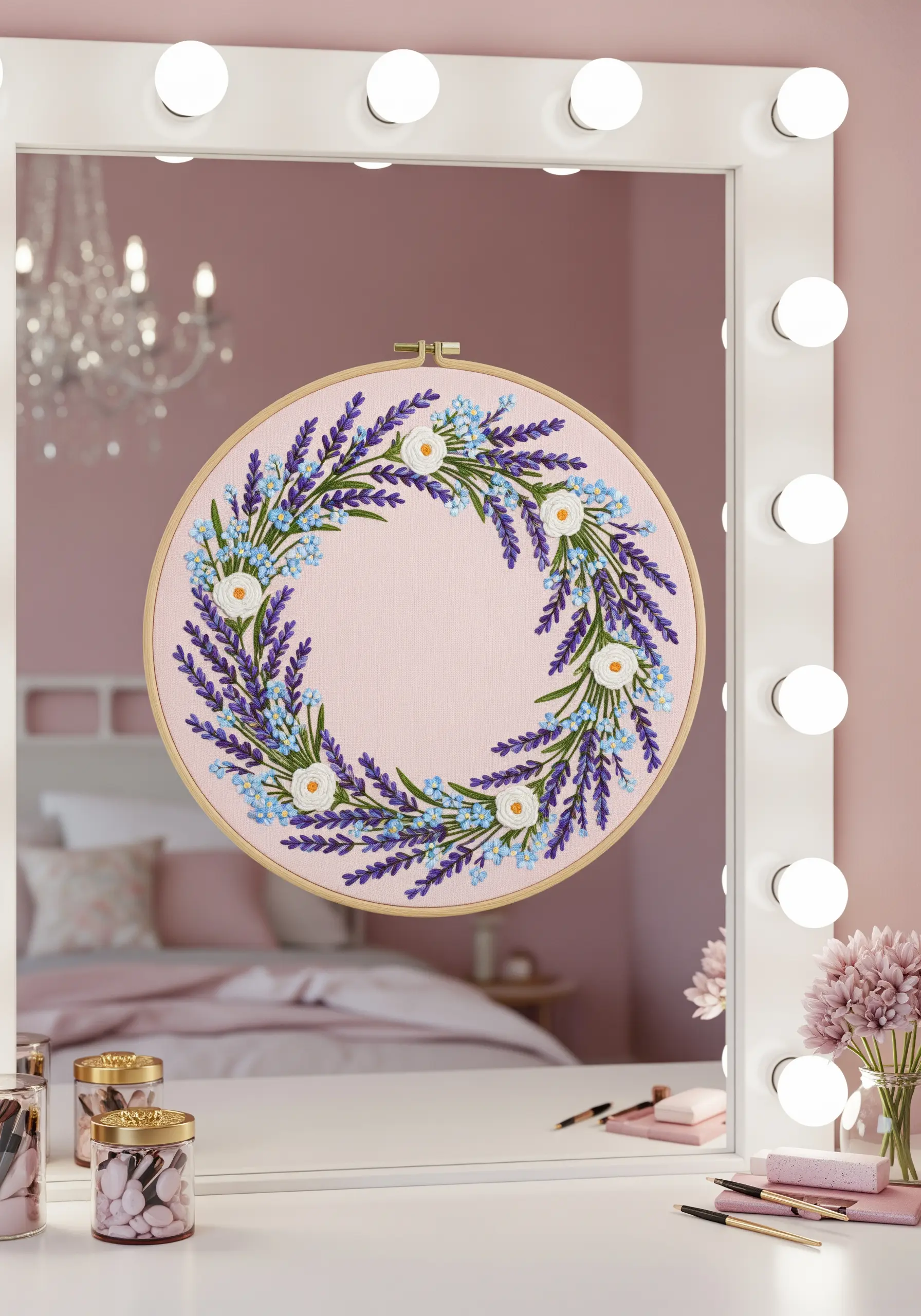 An embroidery hoop with a wreath of lavender and small white flowers on pink fabric.