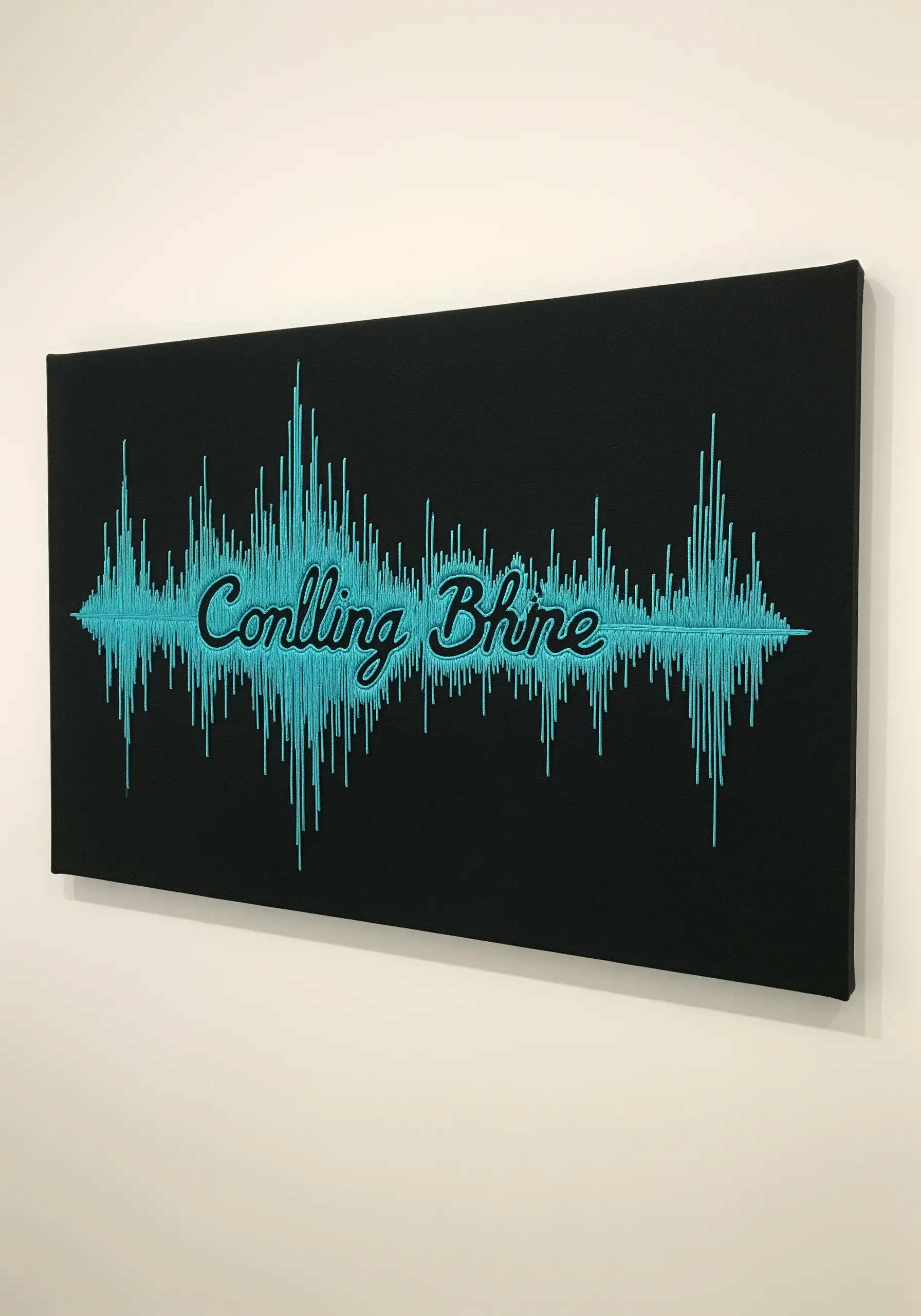 Embroidery of a bright blue audio soundwave on a black stretched canvas, with text stitched over it.