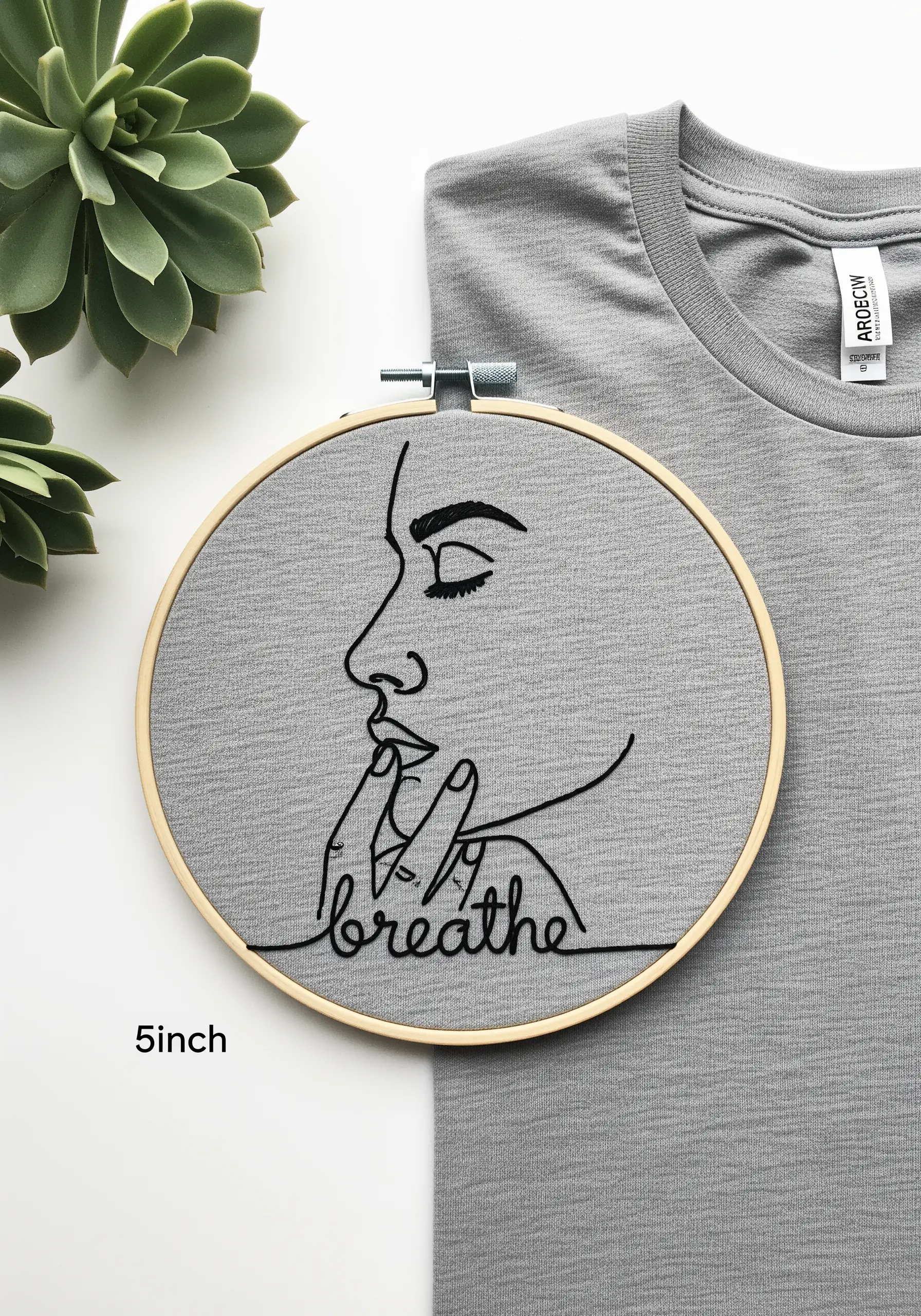 Minimalist face stitched on a t-shirt, showing how to embellish apparel.