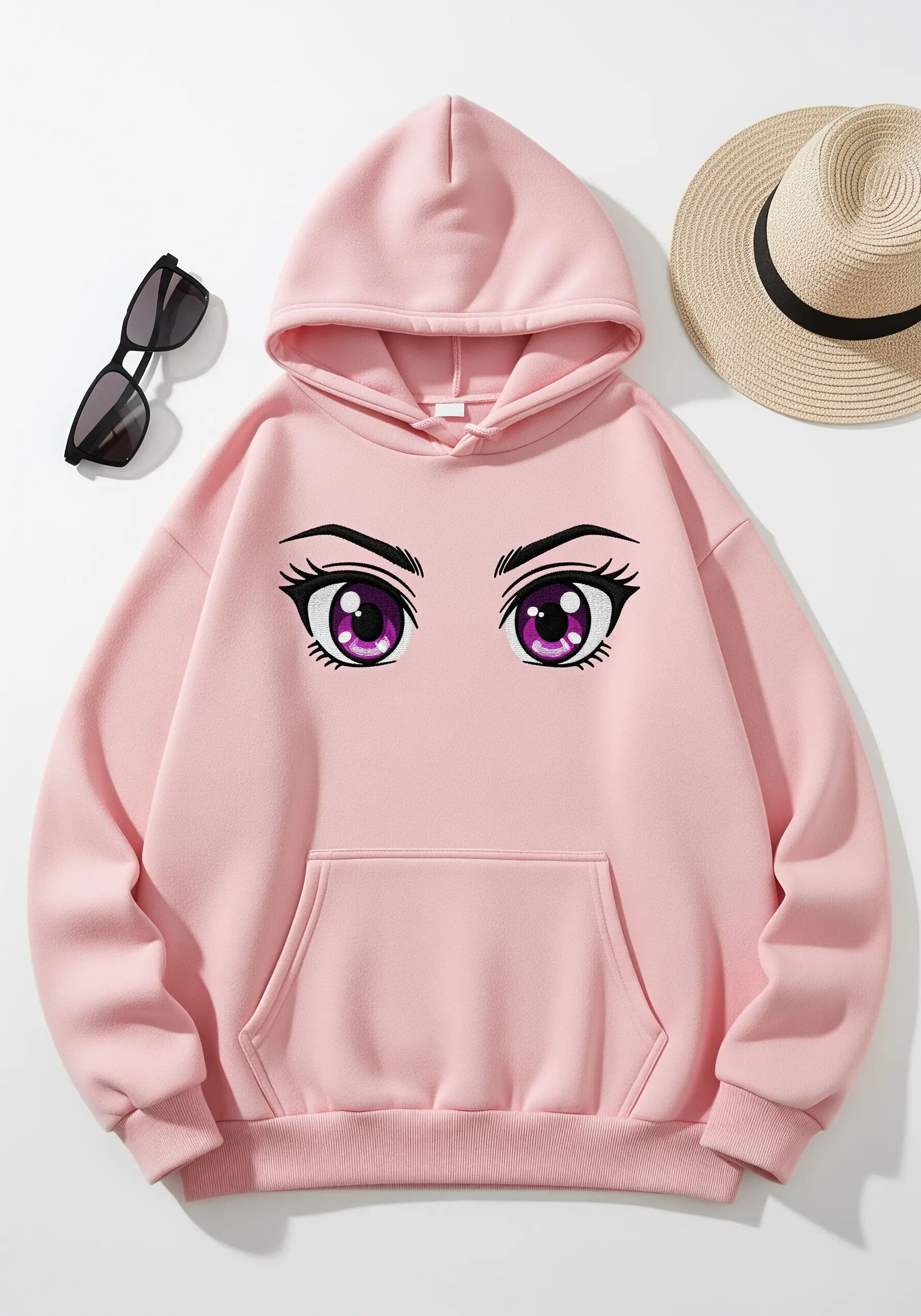 A pair of large, purple anime-style eyes embroidered on the chest of a pink hoodie.