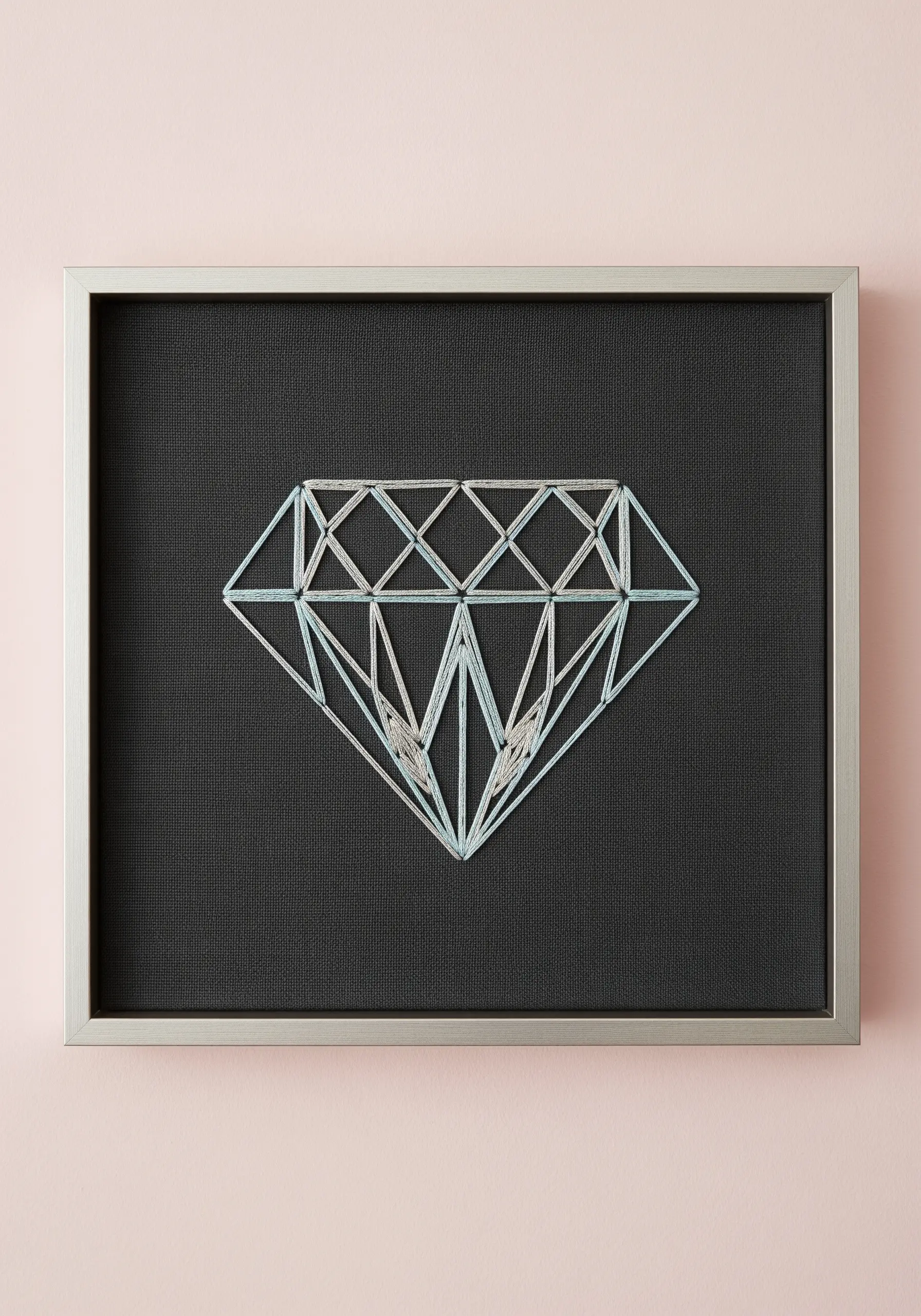 A geometric diamond stitched with intersecting lines of light blue and silver thread on black fabric.
