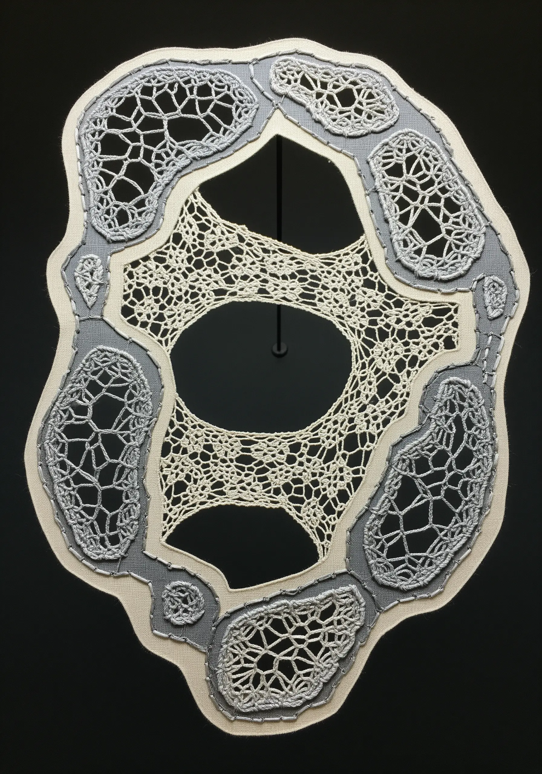 An organic, lace-like embroidery piece made with a soluble stabilizer, creating intricate voids.