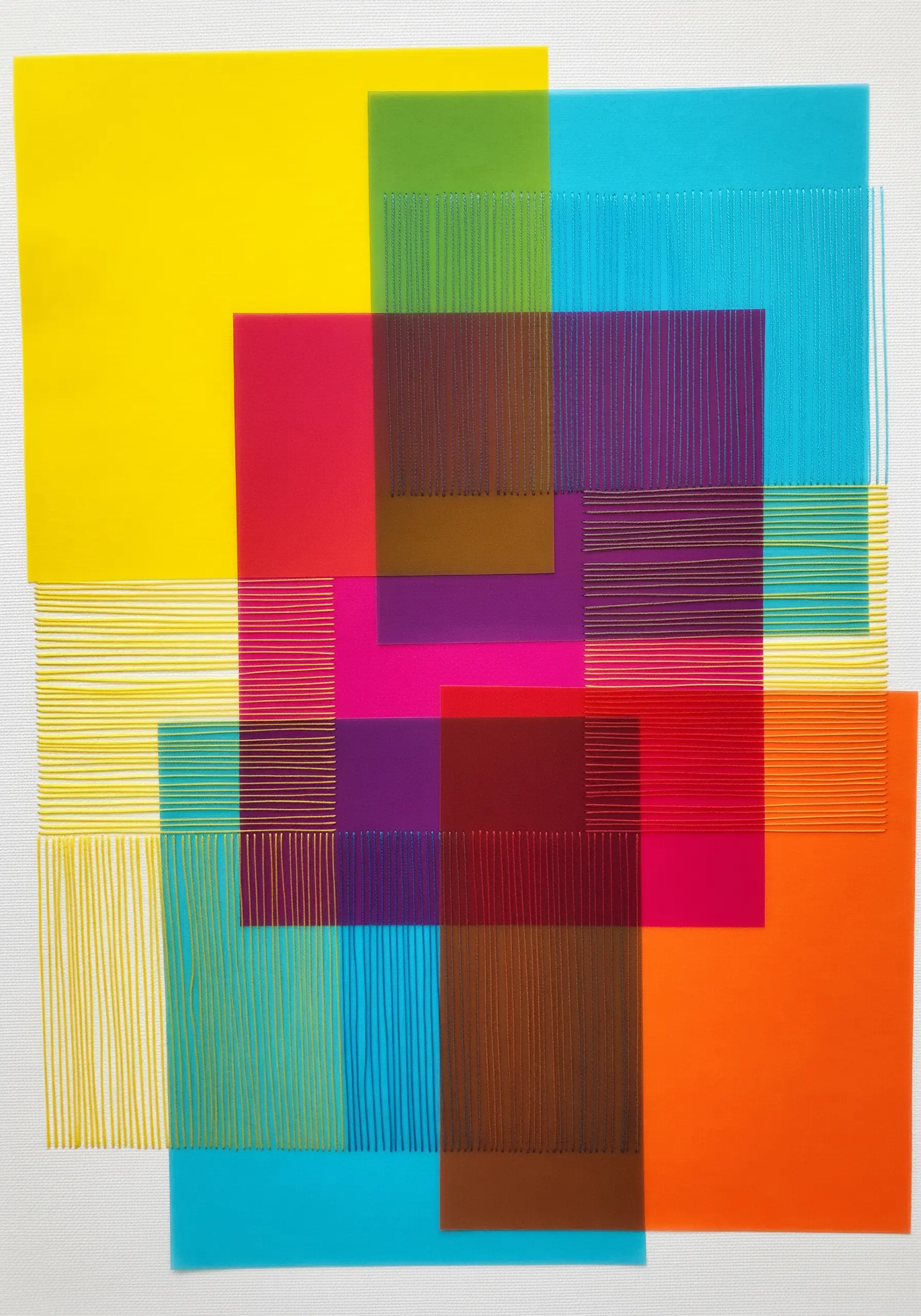 Overlapping translucent color sheets in yellow, blue, and magenta are stitched with parallel lines of thread.