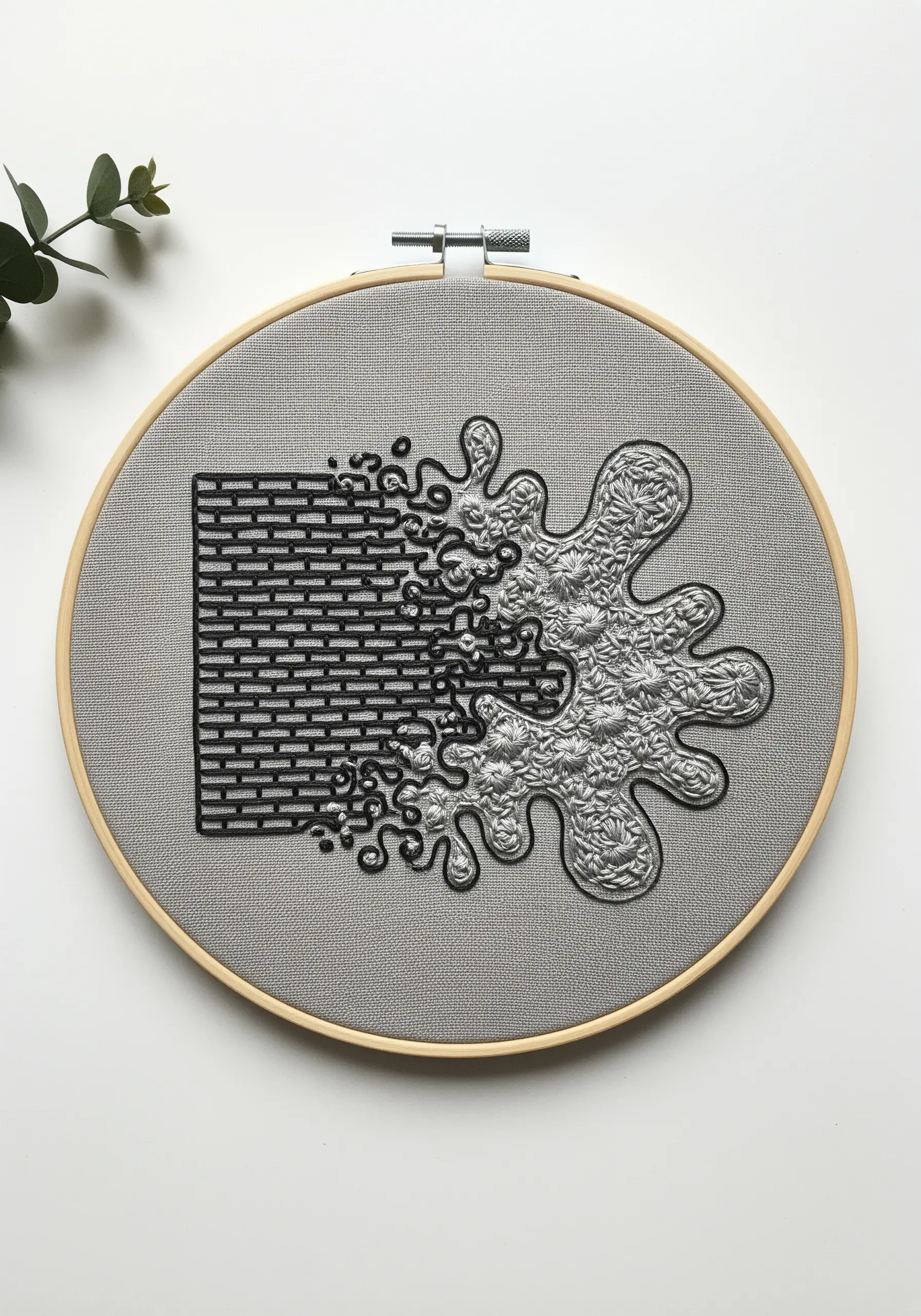 A brick wall pattern dissolving into an abstract splash of grey stitches.