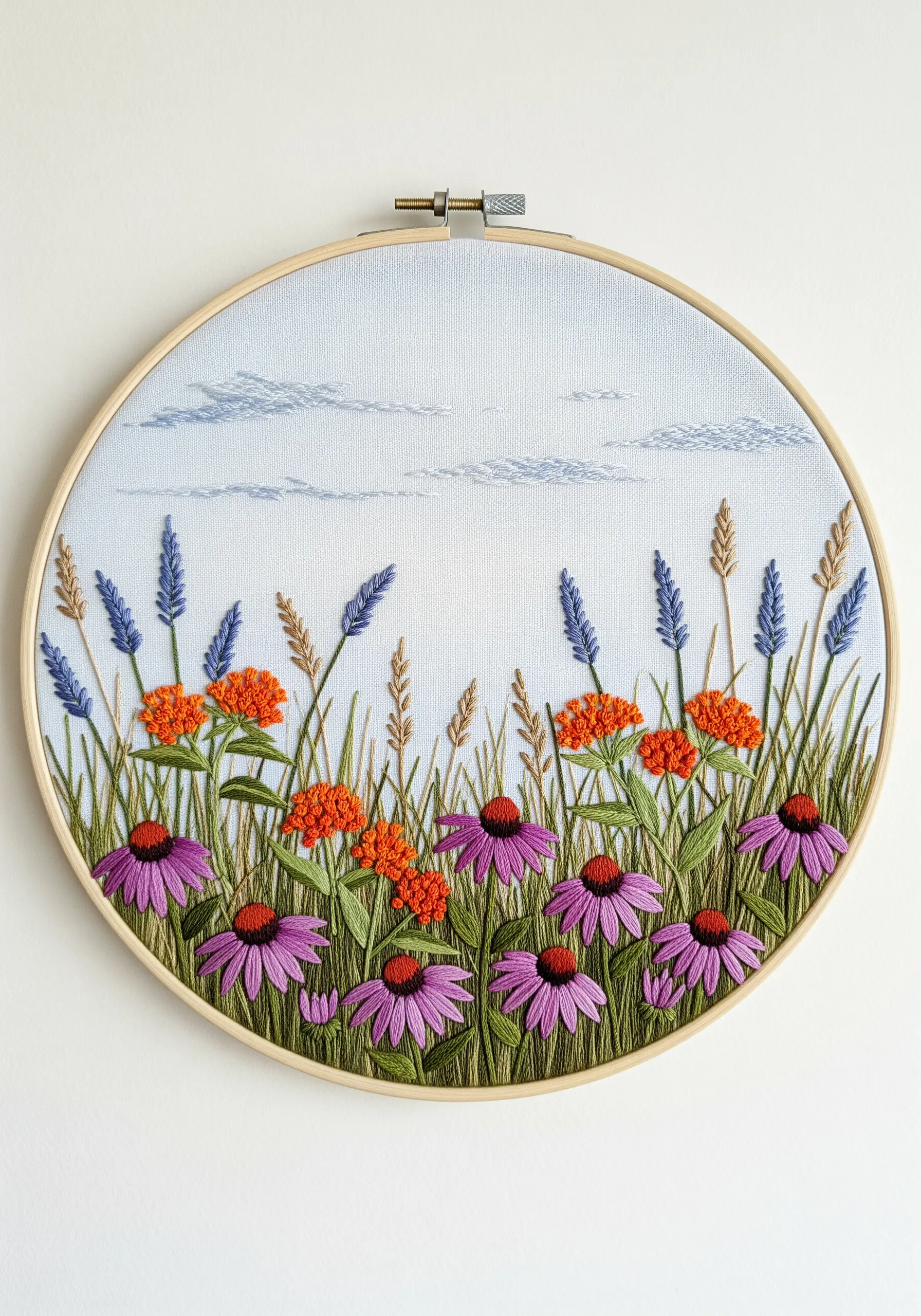 Embroidered meadow with purple coneflowers and orange flowers under a lightly stitched blue sky.