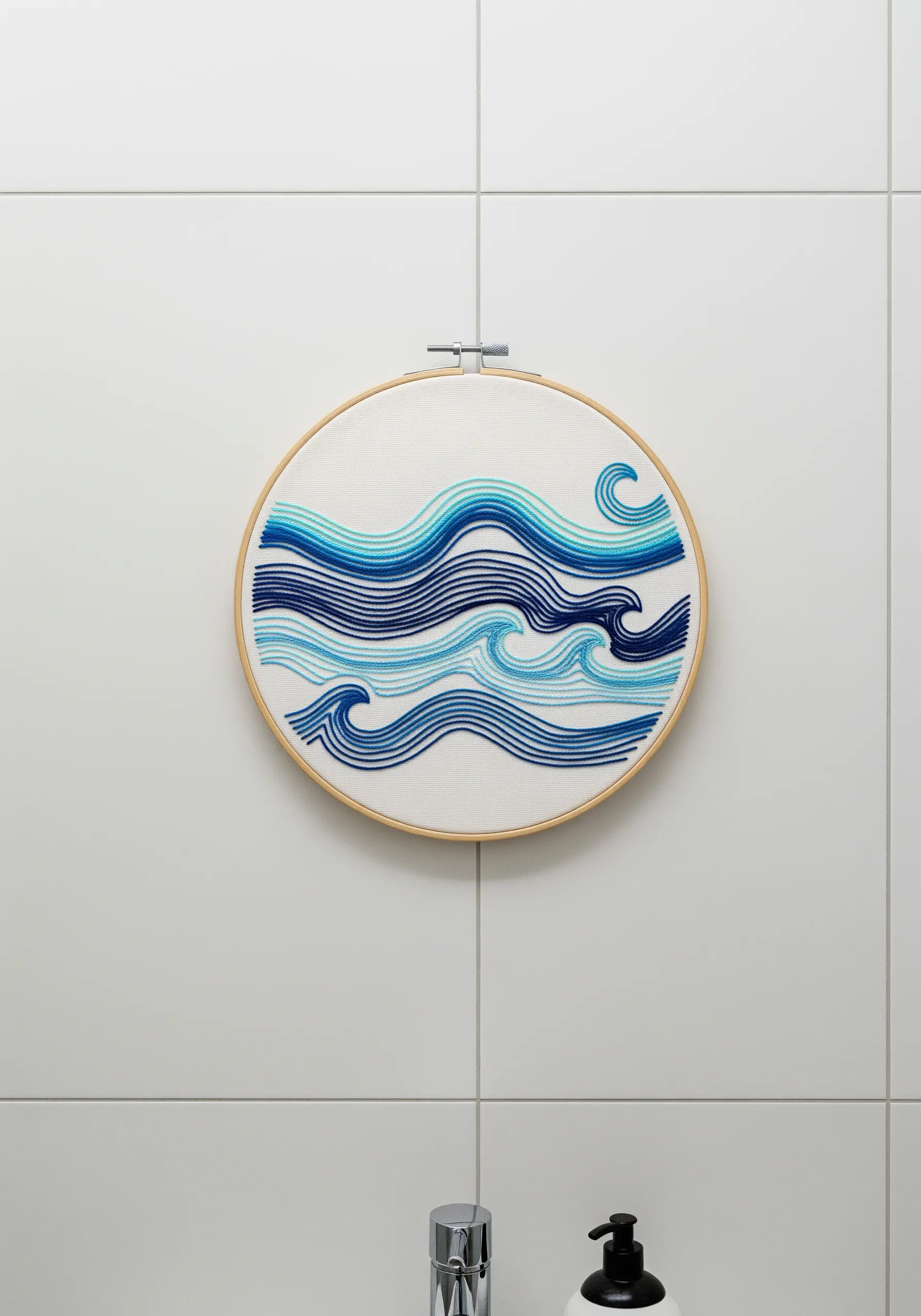 Abstract ocean waves embroidered with parallel lines in graduating shades of blue.