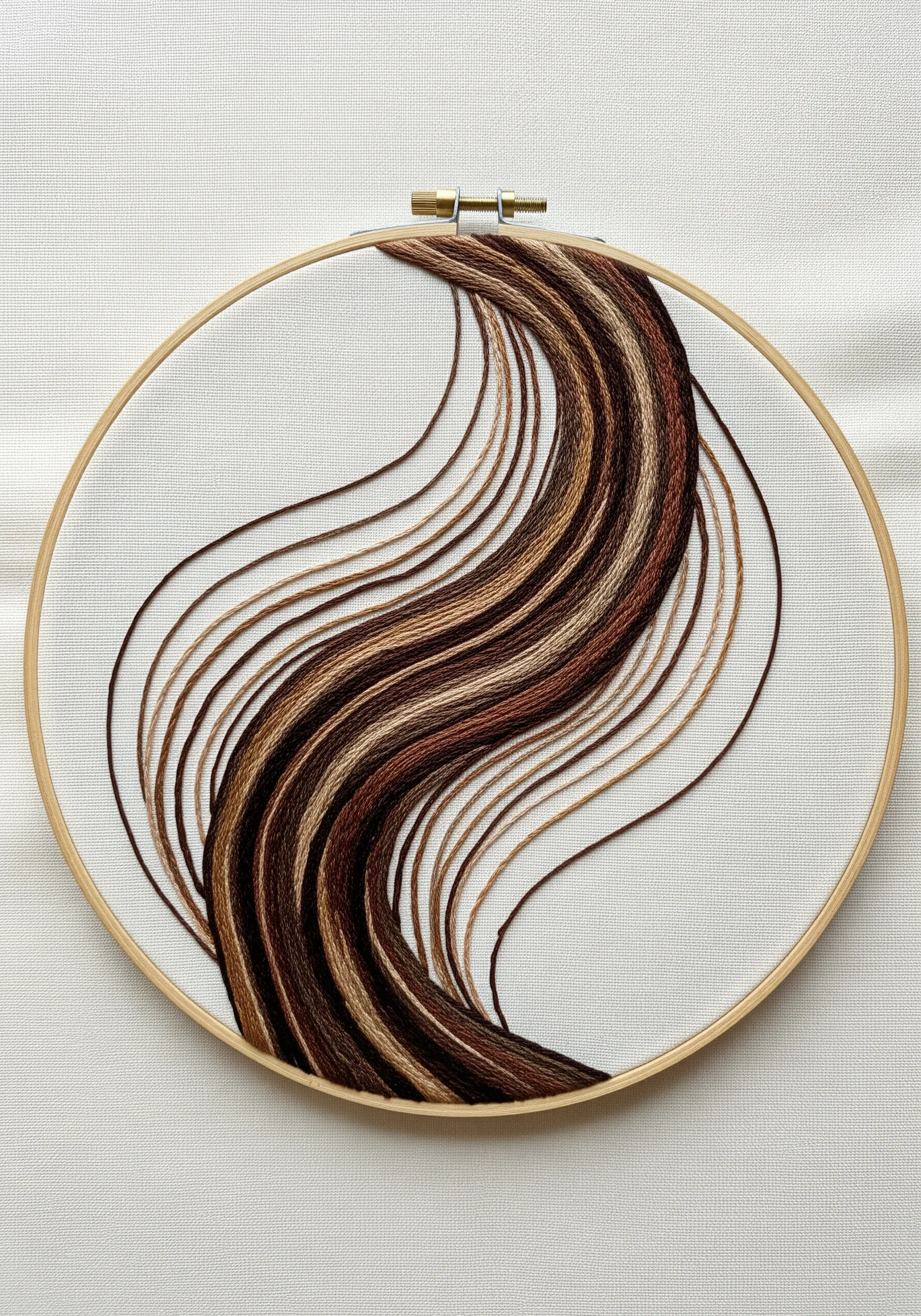 Embroidery of flowing wood grain created with long, sweeping lines of brown and tan thread.