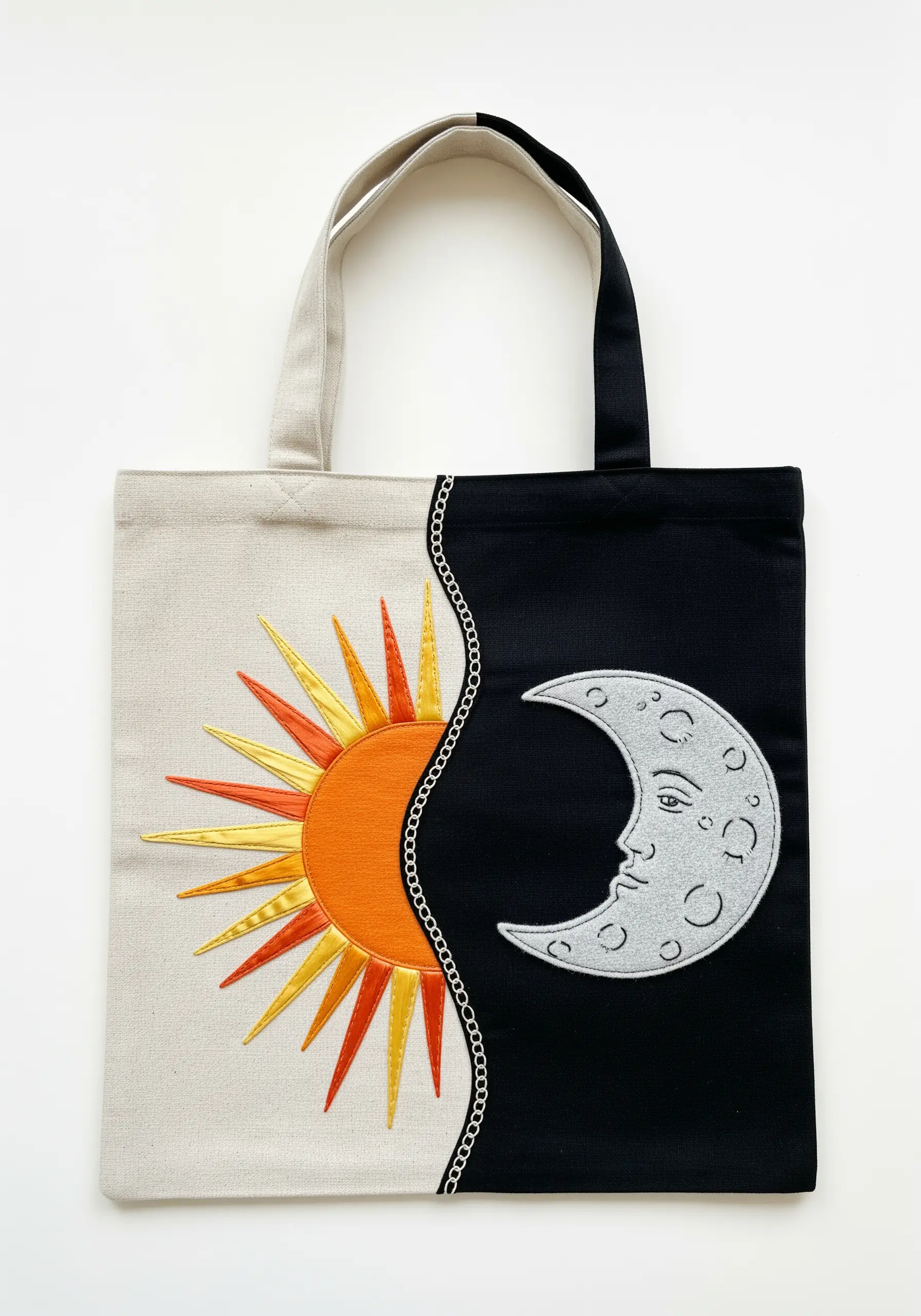 Half sun and half moon design on a split black-and-white tote bag.