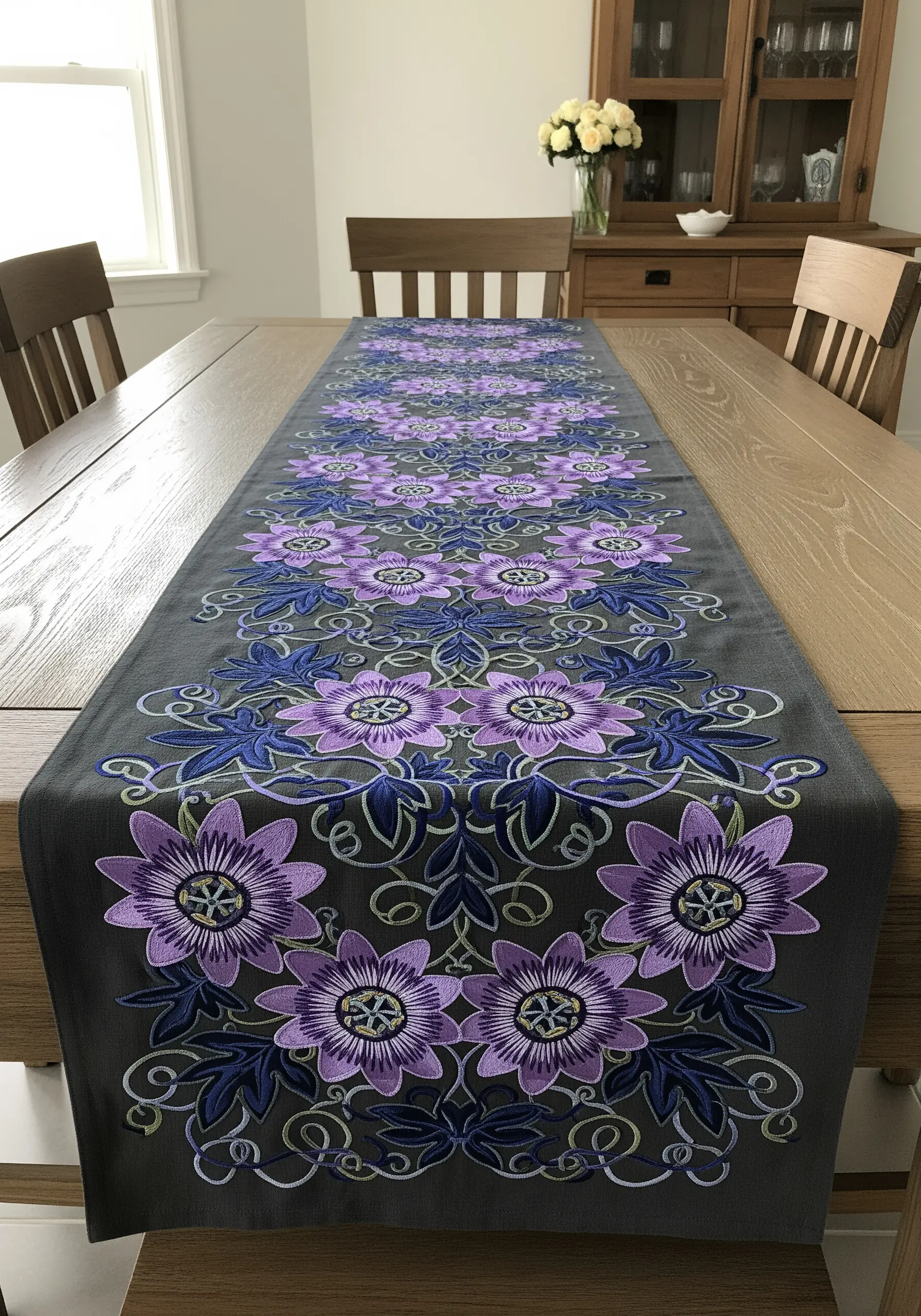 A repeating pattern of embroidered purple passion flowers on a charcoal table runner.