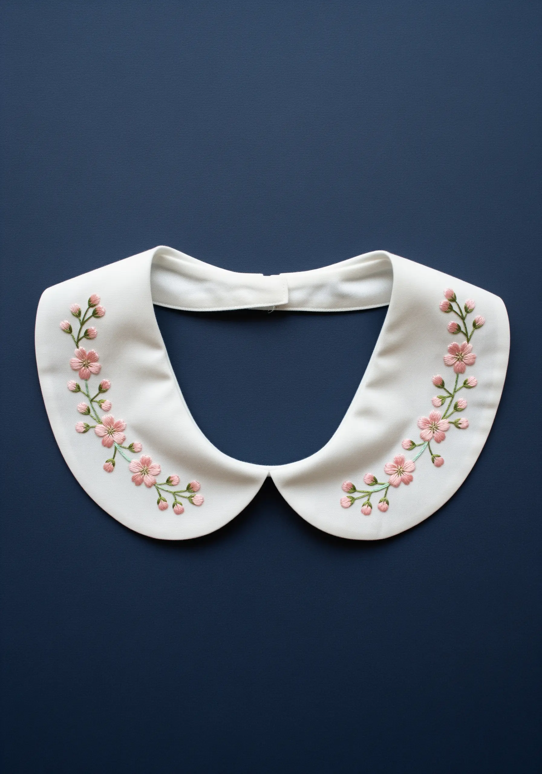 Symmetrical cherry blossom embroidery on a white detachable peter pan collar.