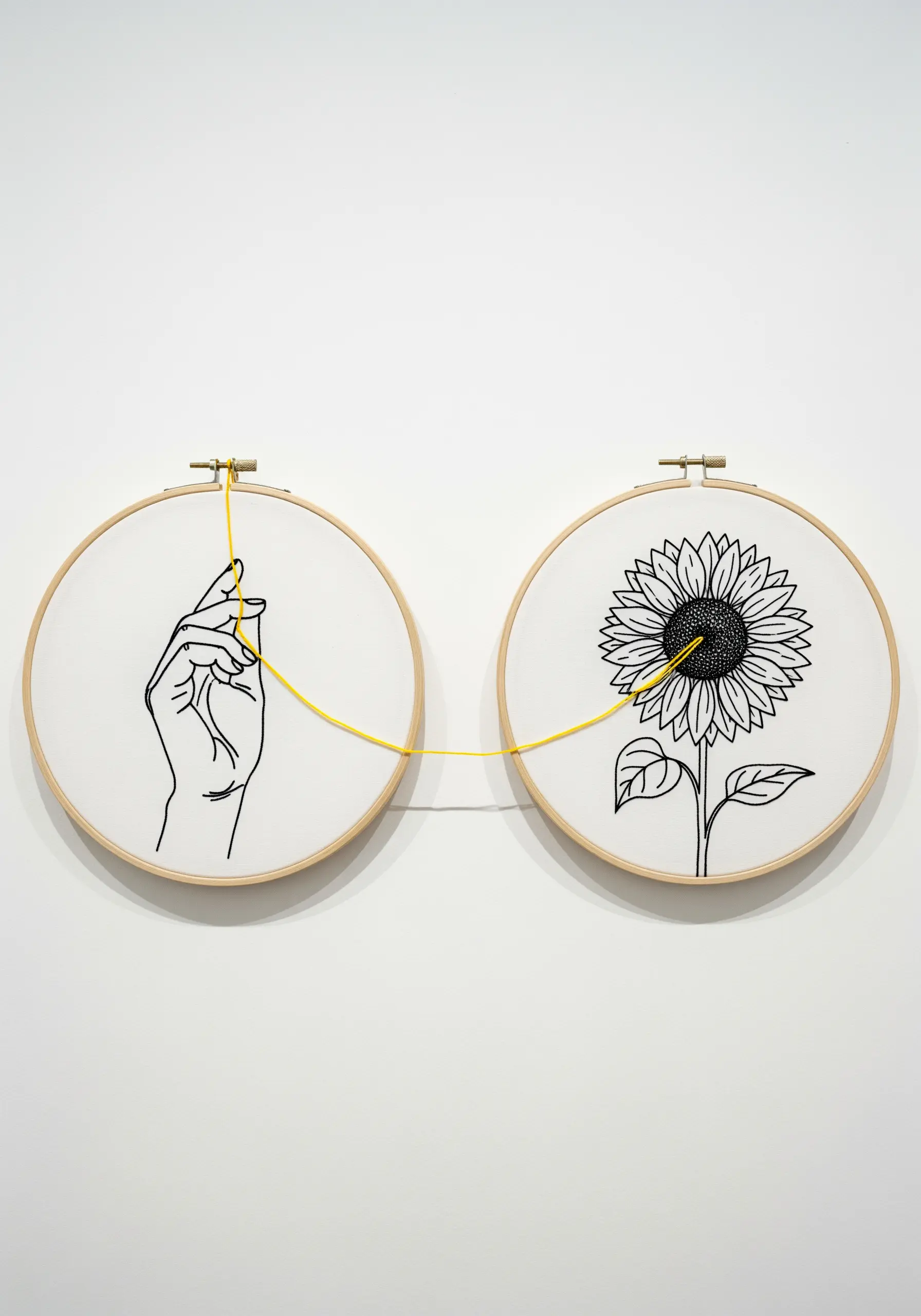 Two embroidery hoops connected by a yellow thread; one has a hand, the other a sunflower.