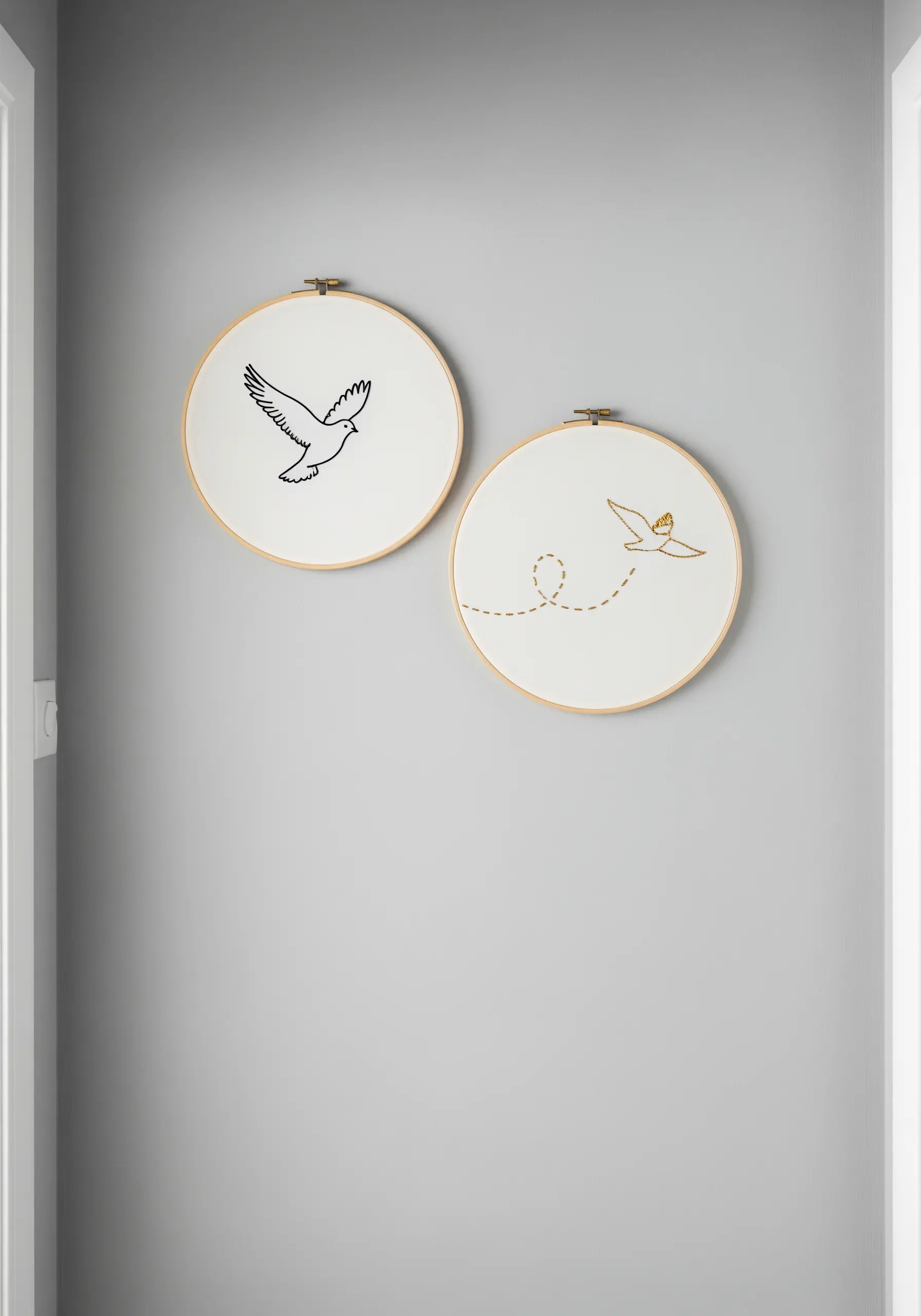 Two embroidery hoops showing a narrative: one bird in black, the other a gold outline with a crown.