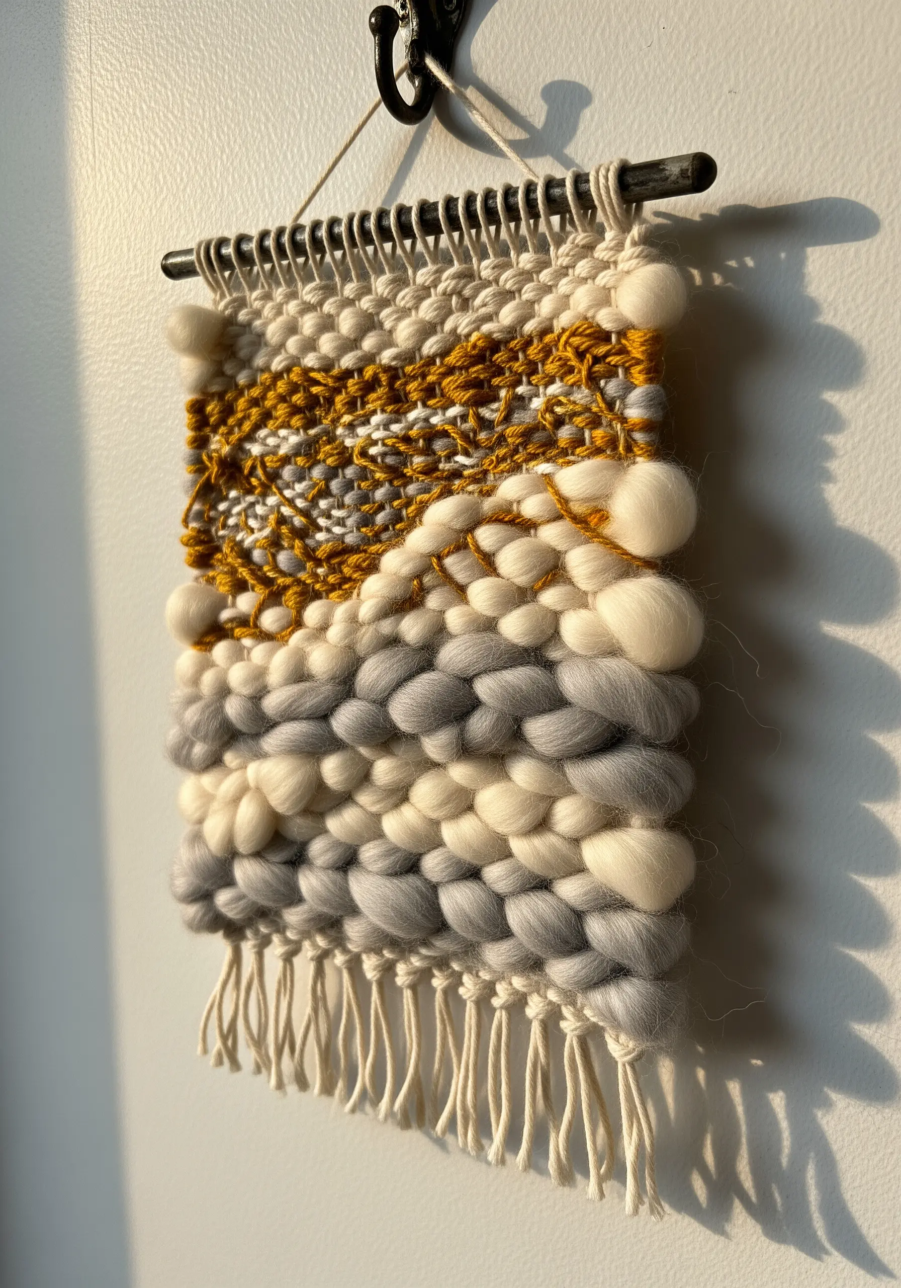 Small woven wall hanging with mustard, grey, and cream wool