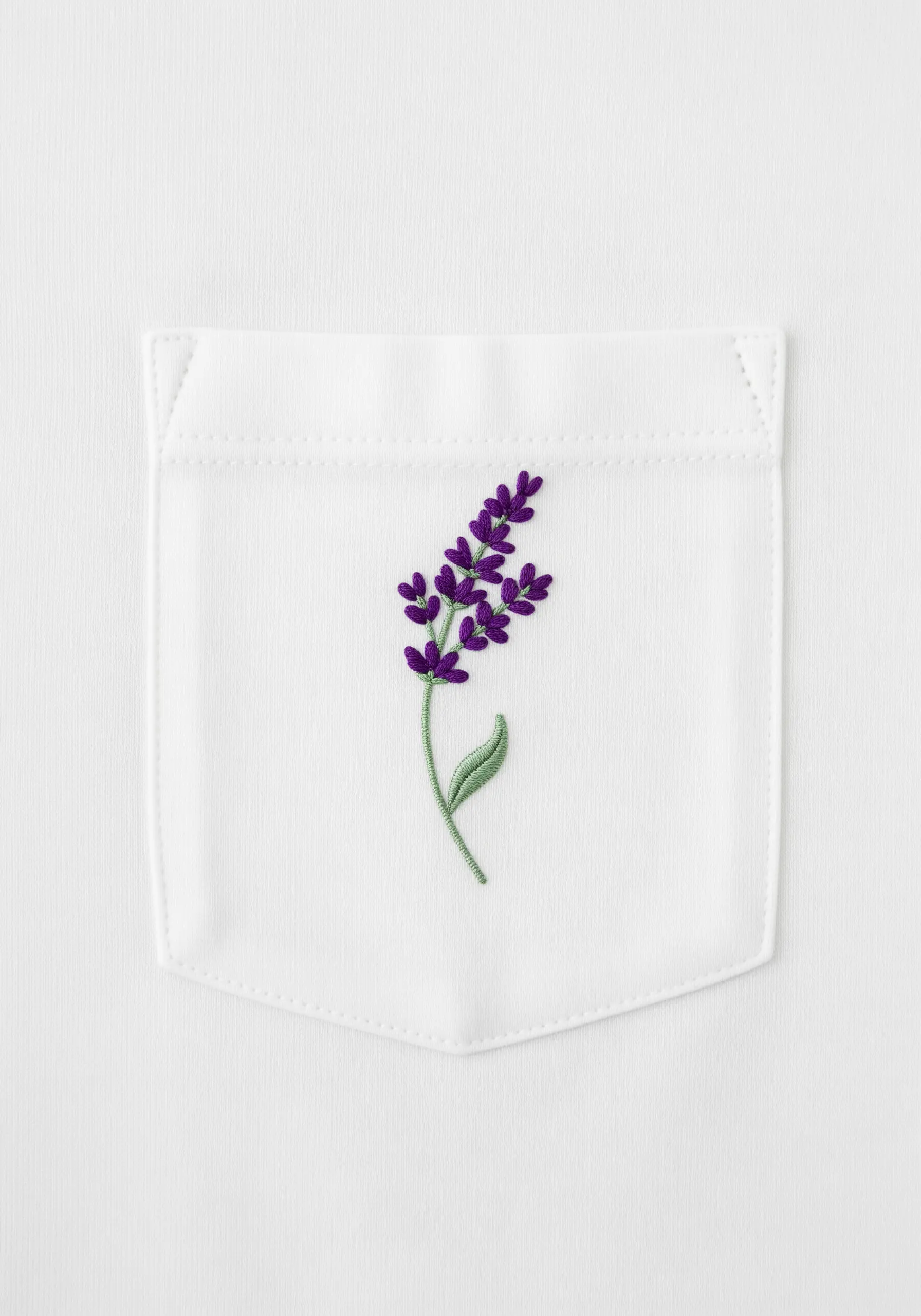 A vibrant purple lavender sprig embroidered on the pocket of a white t-shirt.
