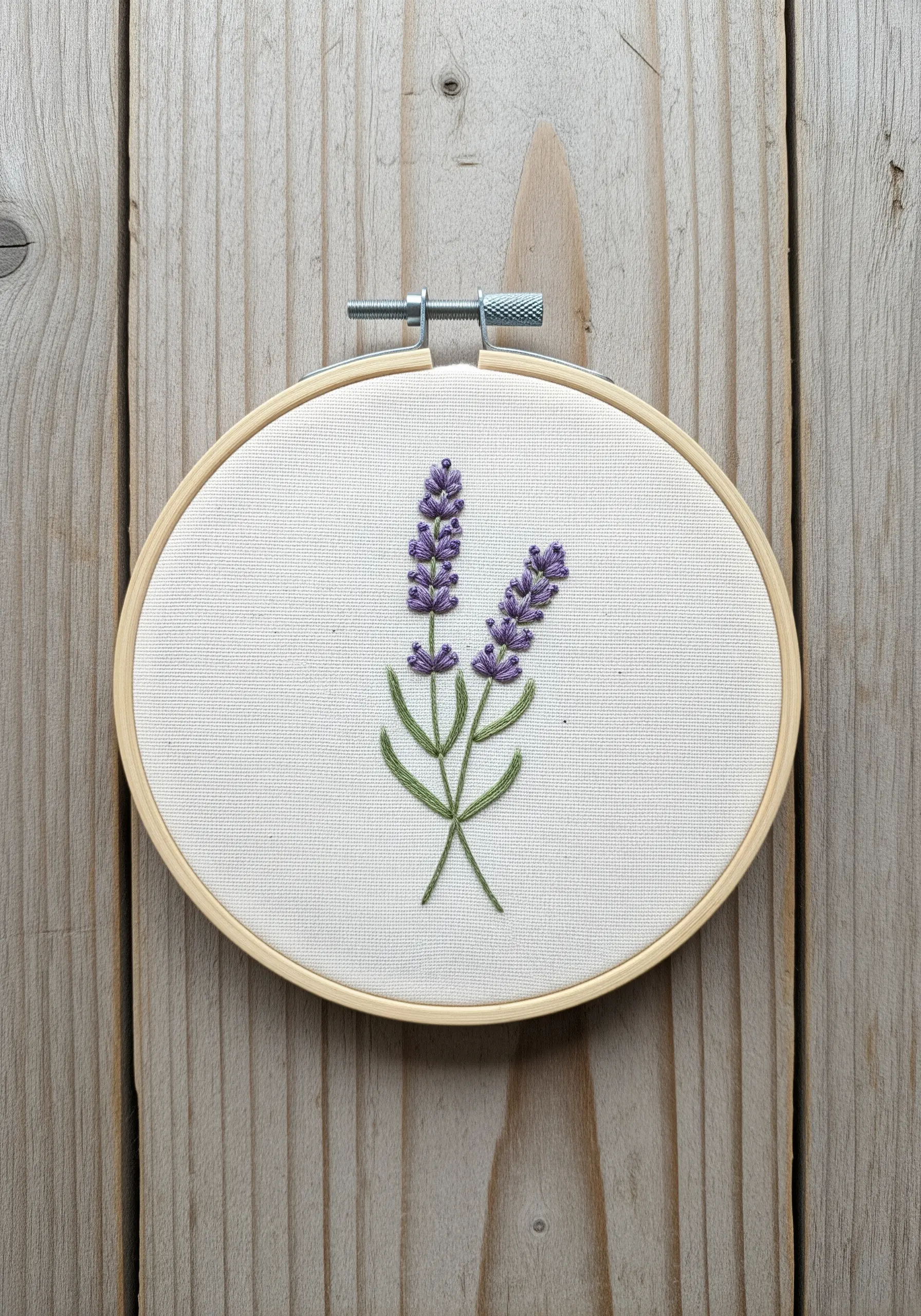 Two lavender sprigs embroidered with French knots and stem stitch.