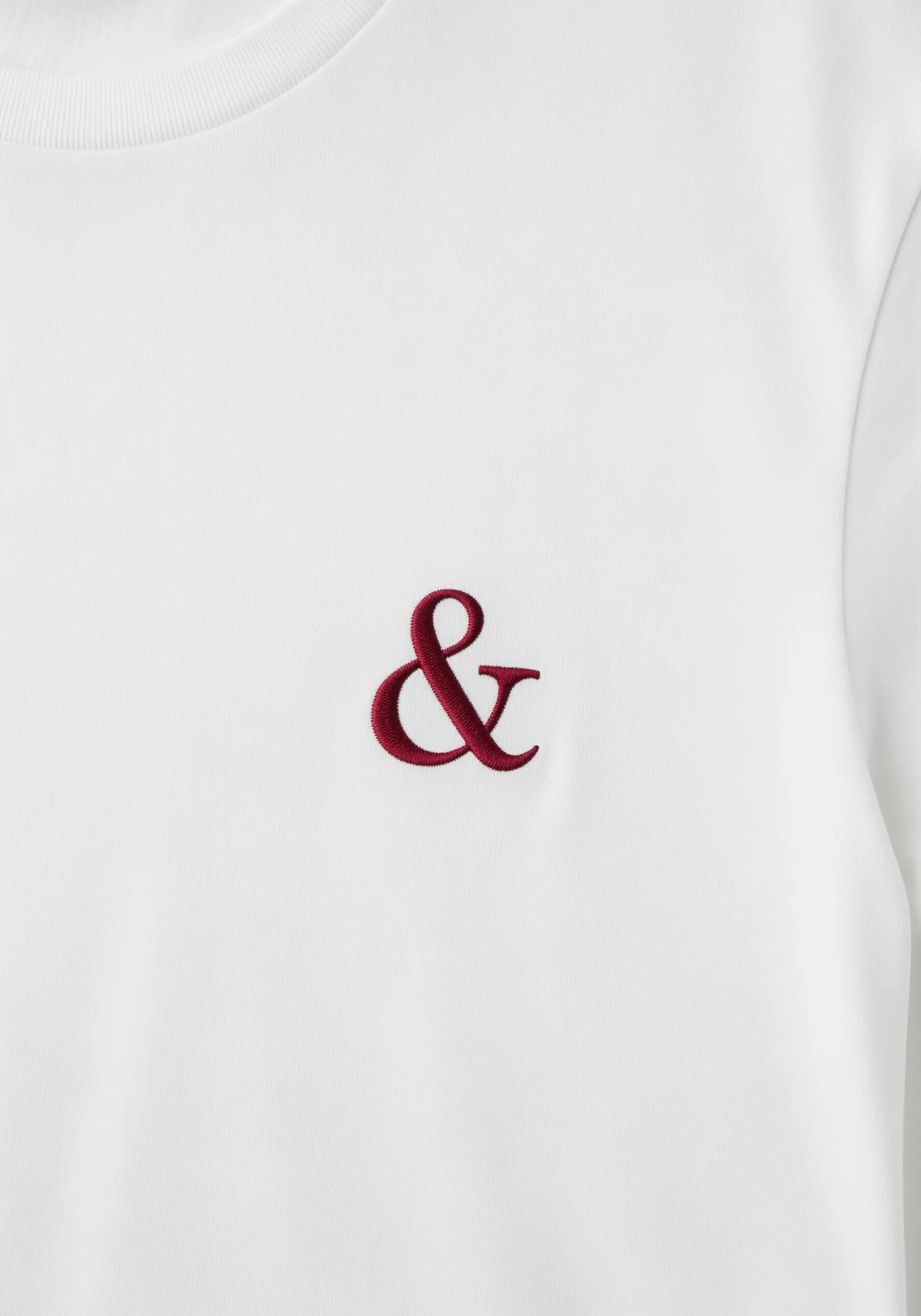 A classic ampersand symbol stitched in rich burgundy thread.