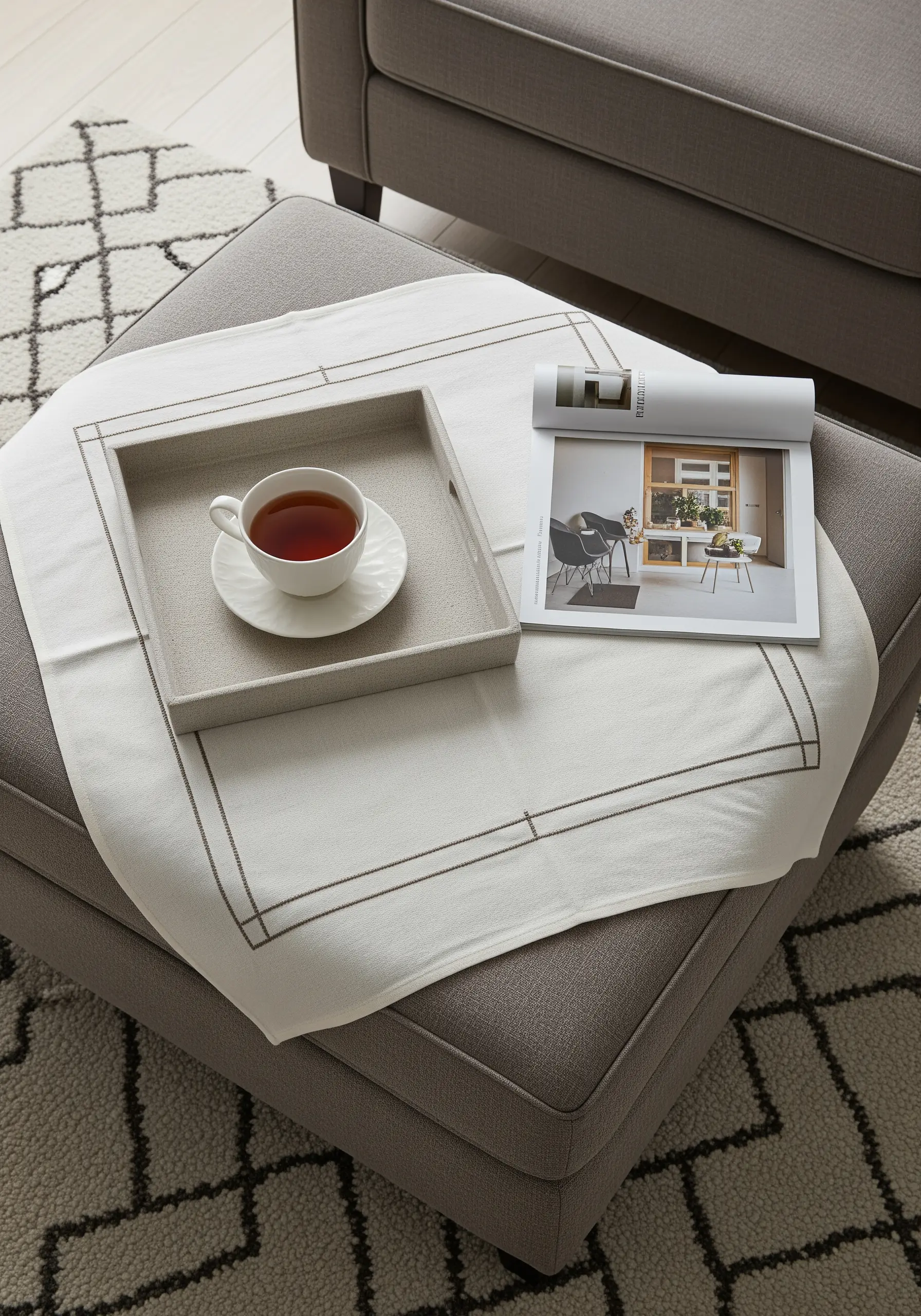 A white linen cloth with a geometric drawn thread (hemstitch) border.