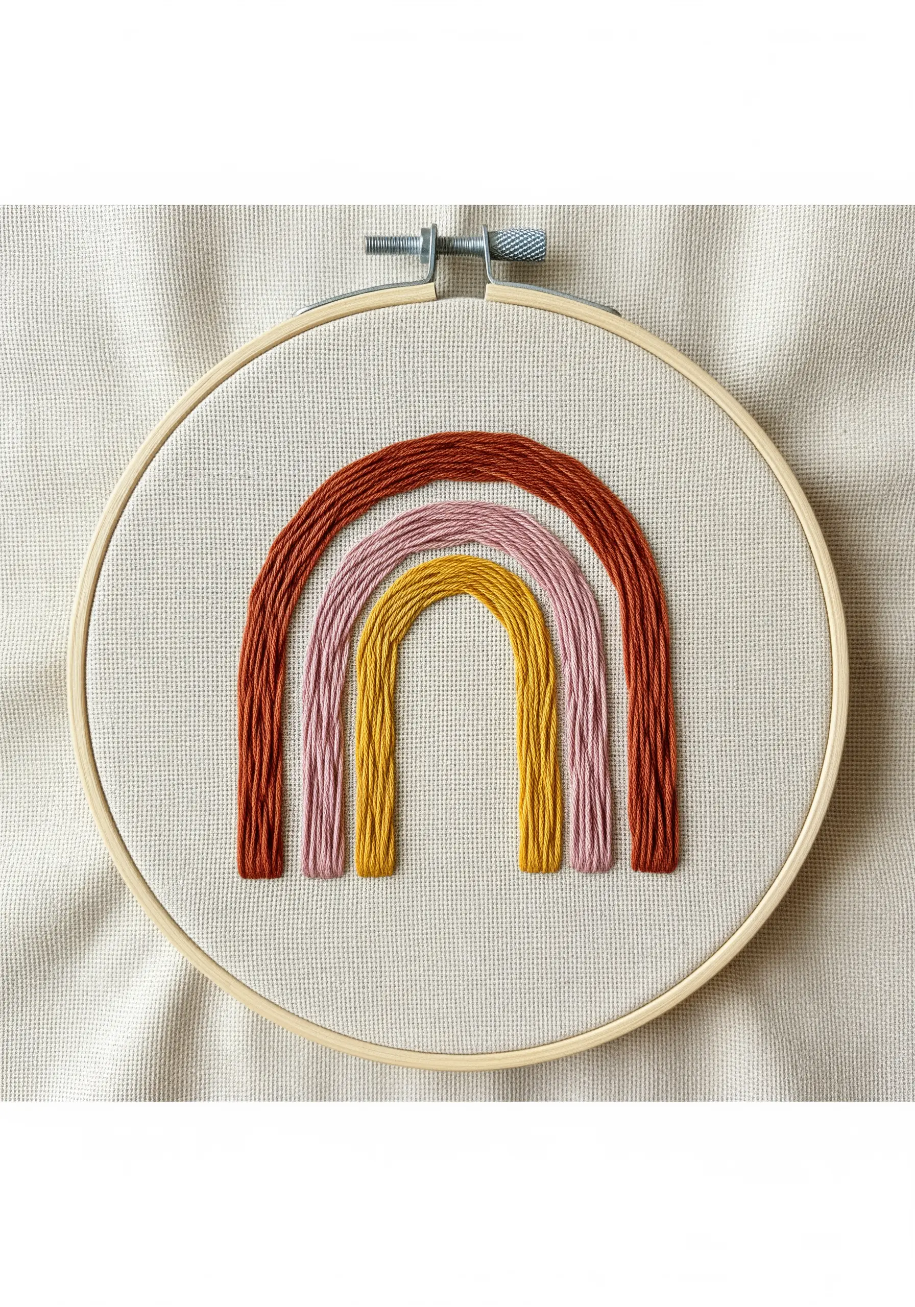 Modern rainbow with four arches in earthy tones, embroidered with thick satin stitch.