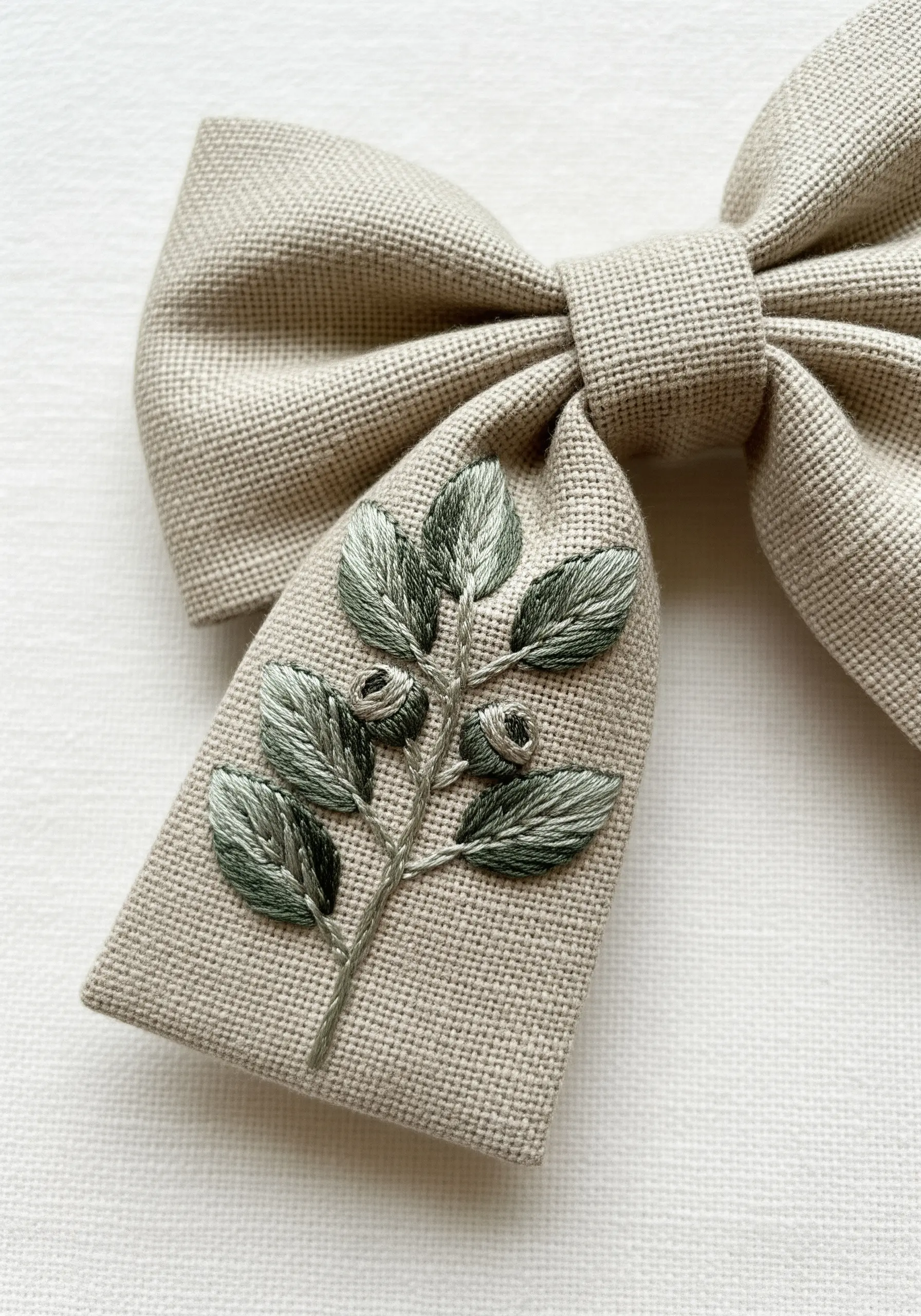 Green fishbone stitch leaf embroidery on linen bow