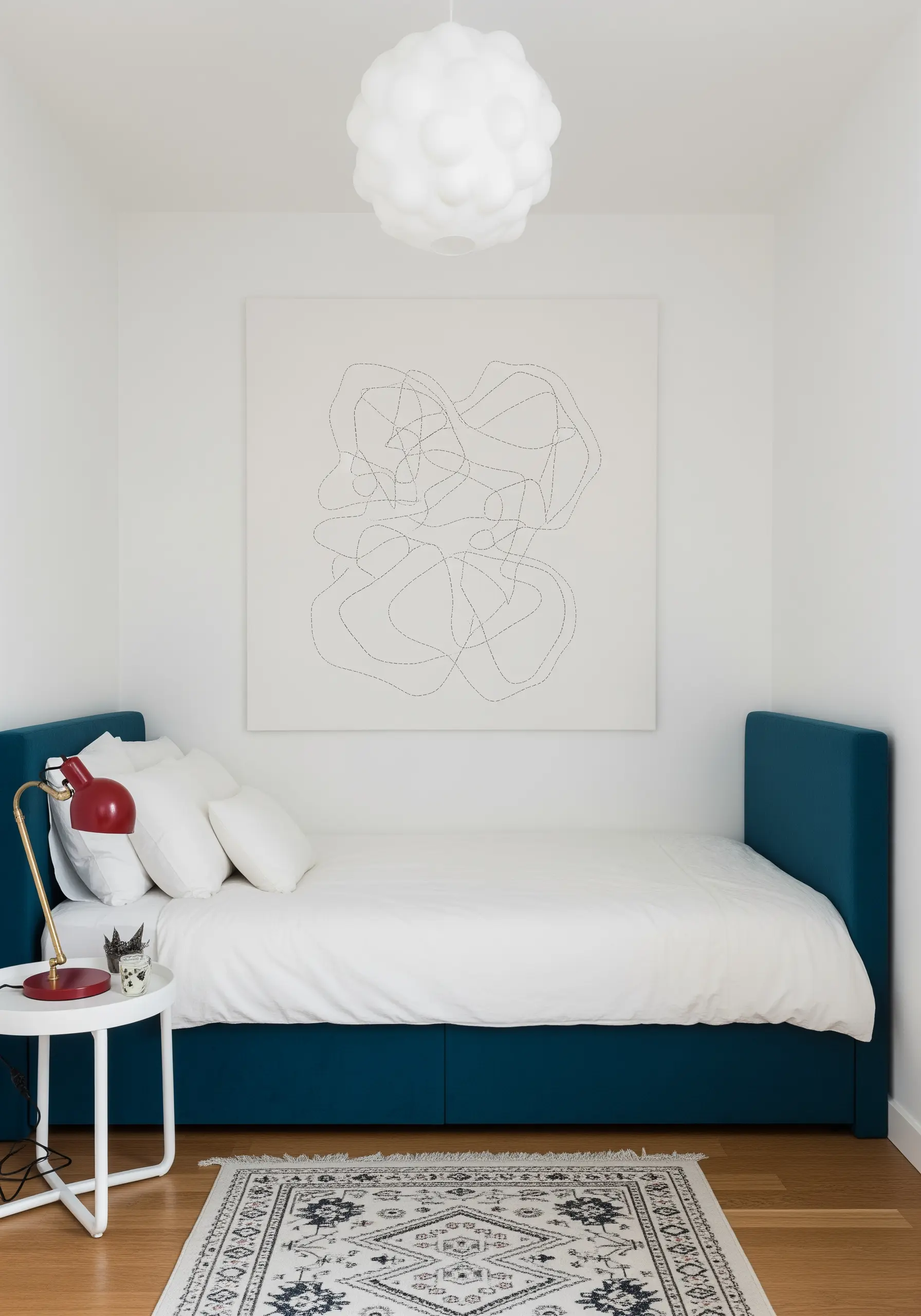 A large white canvas with a single black thread stitched in a continuous, abstract scribble.