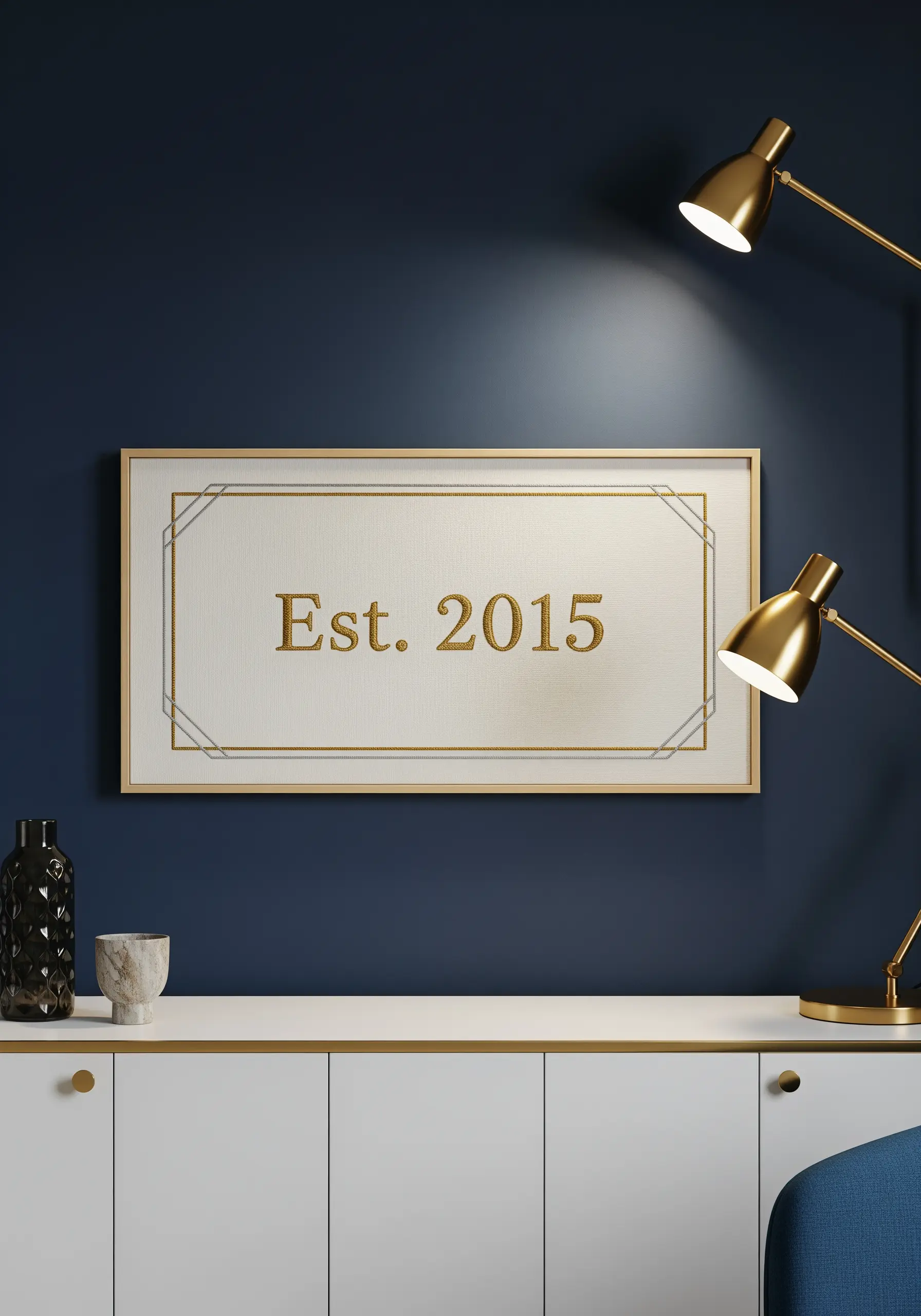 Framed embroidery of an establishment date stitched in elegant gold metallic thread.