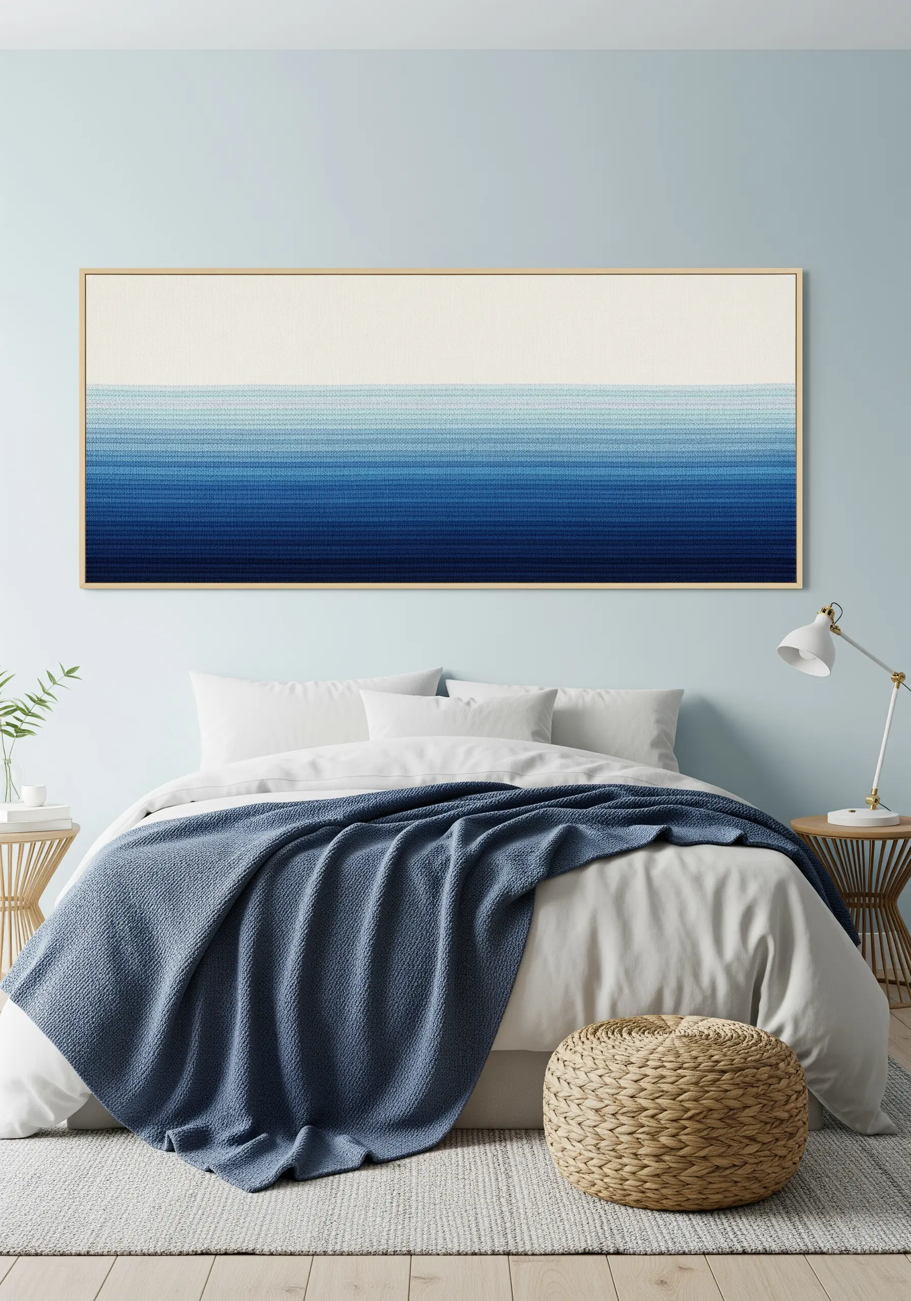 A long, framed piece of embroidery showing a smooth gradient from white to deep blue.
